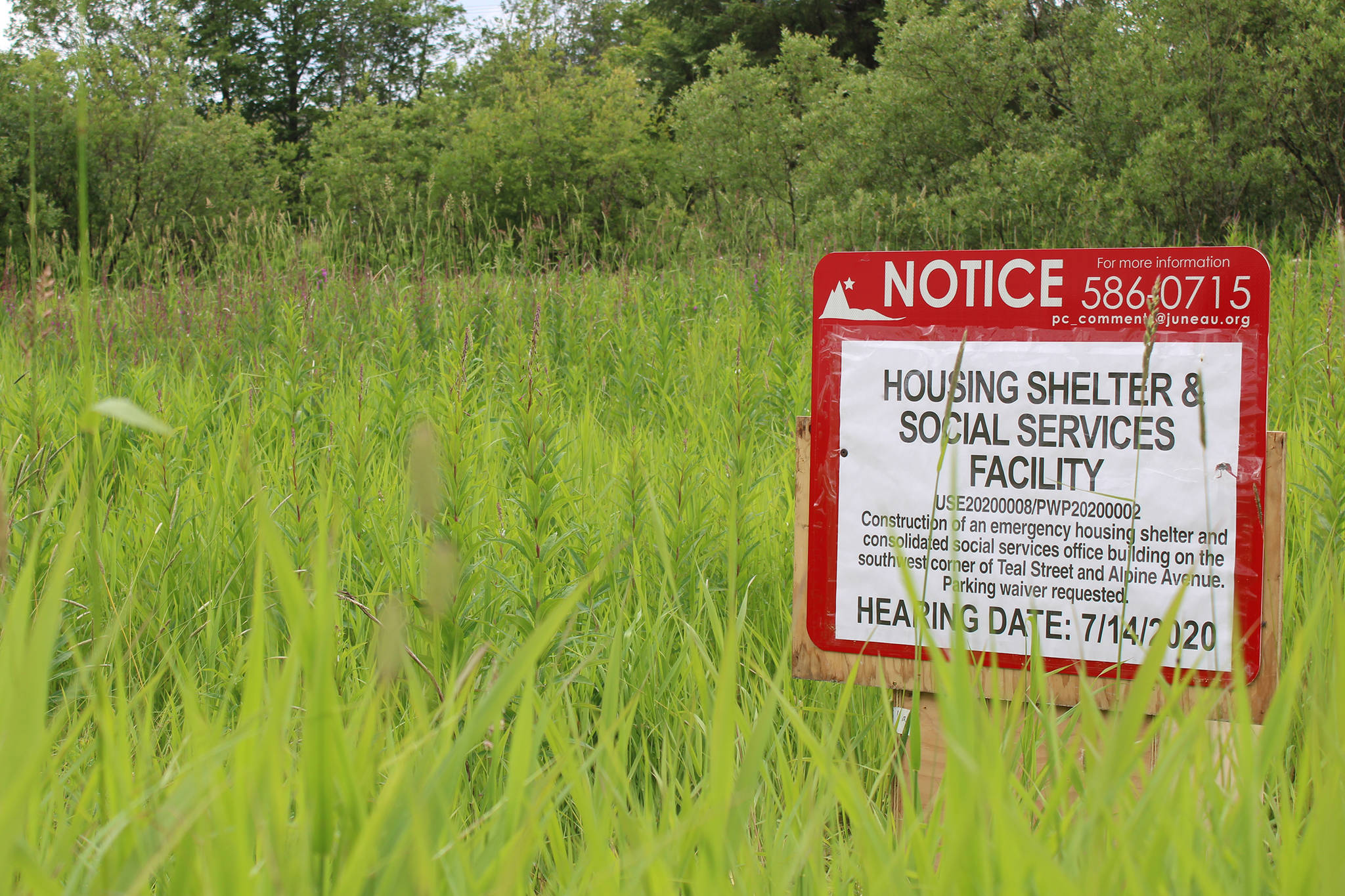 A sign marks the site of a proposed social services campus at 8617 Teal Street near the Juneau International Airport. The City and Borough of Juneau Planning Commission will vote to approve two permits necessary for the project to continue at a July 14 meeting. (Ben Hohenstatt | Juneau Empire)
