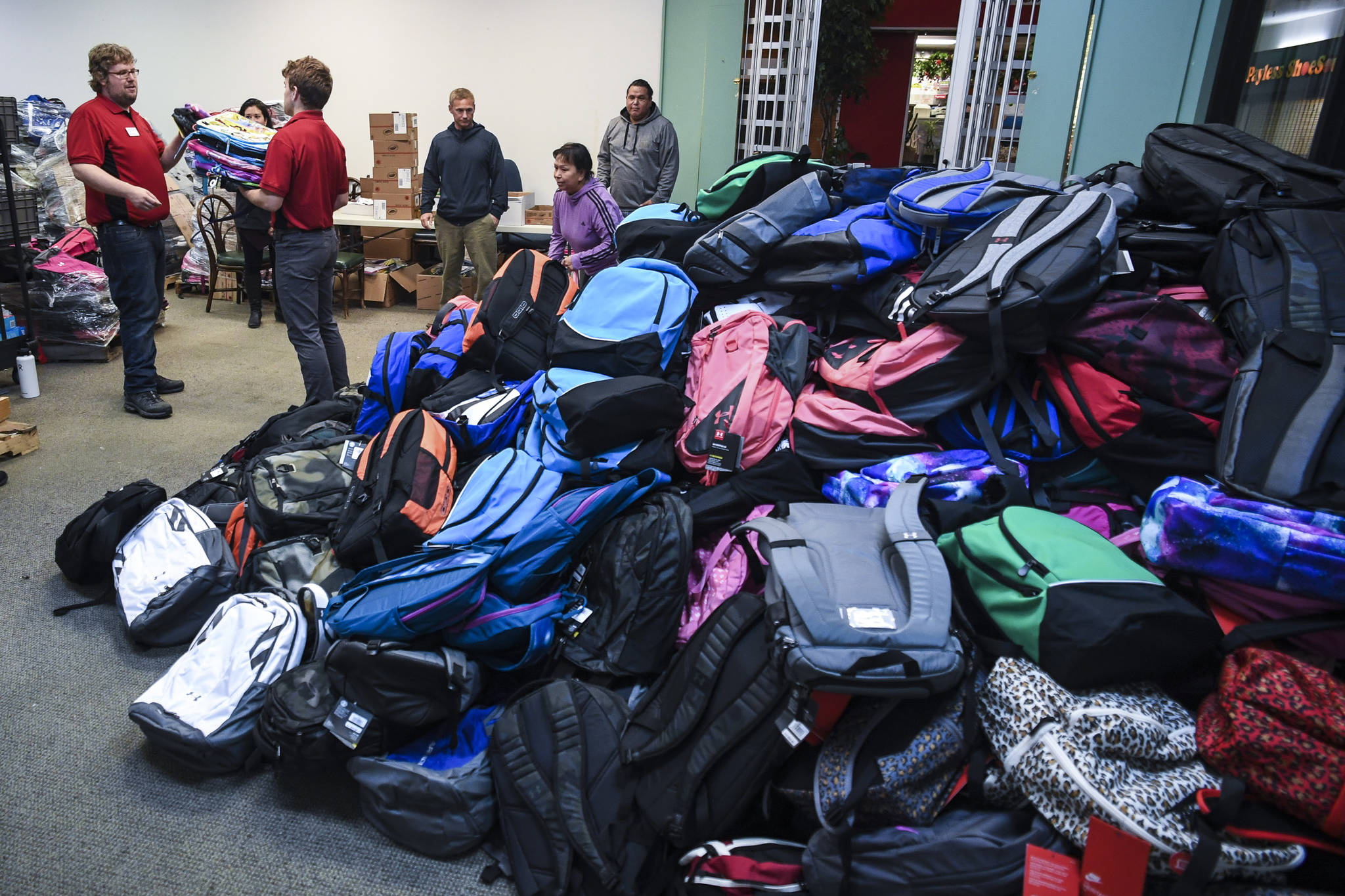 This July 2019 photo shows some of over 2,000 backpacks that were given away to students throughout Southeast Alaska through Tlingit and Haida’s Temporary Assistance For Needy Families Department. This year in order to help accommodate virtual learning, when backpacks are distributed, they will come with Google Chromebooks. (Michael Penn | Juneau Empire File)