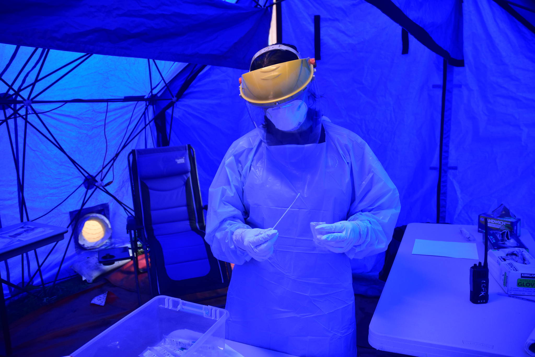 Peter Segall | Juneau Empire                                 Capital City Fire/Rescue firefighter/EMT Jessica Skiba holds a COVID-19 test sample at the citys drive-thru screening site at the Hagevig Regional Fire Training Center in the Mendenhall Valley on Monday, June 29, 2020. The number of coronavirus cases is growing both locally and nationally.