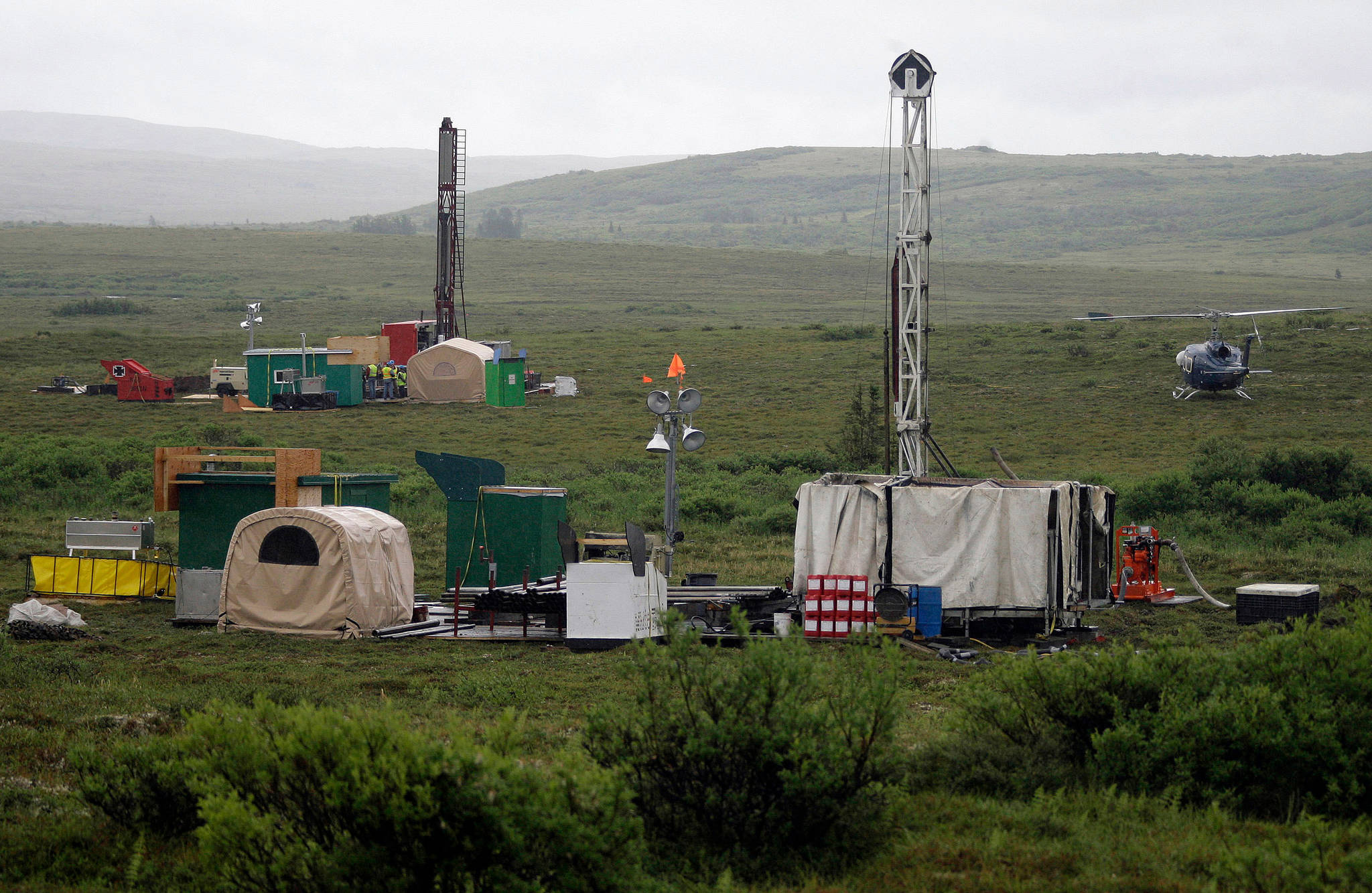 In this July 2007 photo, workers with the Pebble Mine project test drill in the Bristol Bay region of Alaska, near the village of Iliamma. The Pebble Limited Partnership, which wants to build a copper and gold mine near the headwaters of a major U.S. salmon fishery in southwest Alaska, says it plans to offer residents in the region a dividend. (AP Photo/Al Grillo, File)