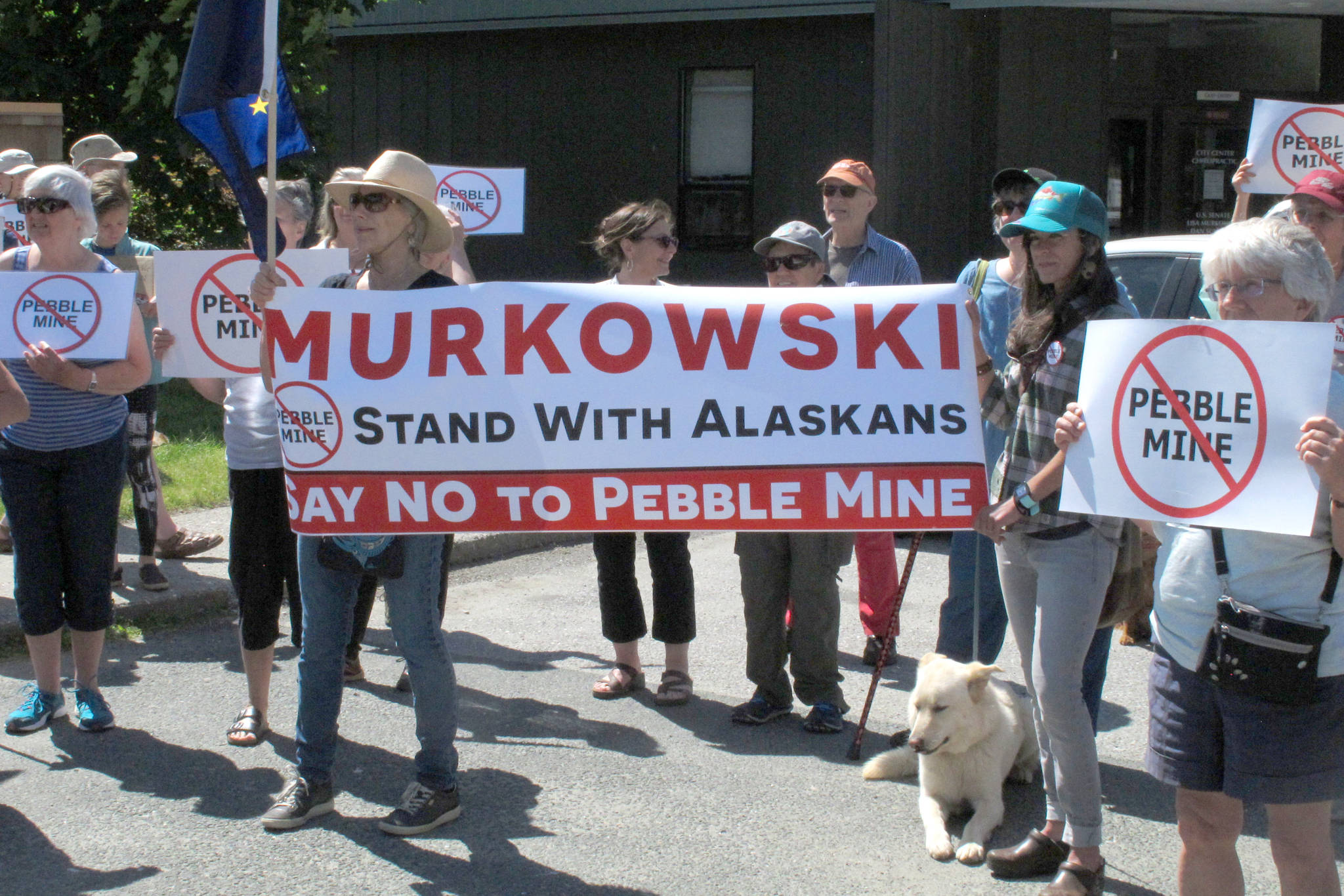 In this June 2019 photo, people gather outside U.S. Sen. Lisa Murkowski’s office in Juneau, Alaska, to protest the proposed Pebble Mine. The Pebble Limited Partnership, which wants to build a copper and gold mine near the headwaters of a major U.S. salmon fishery in southwest Alaska, says it plans to offer residents in the region a dividend. (AP Photo/Becky Bohrer, File)                                In this June 2019 photo, people gather outside U.S. Sen. Lisa Murkowski’s office in Juneau, Alaska, to protest the proposed Pebble Mine. The Pebble Limited Partnership, which wants to build a copper and gold mine near the headwaters of a major U.S. salmon fishery in southwest Alaska, says it plans to offer residents in the region a dividend. (AP Photo/Becky Bohrer, File)