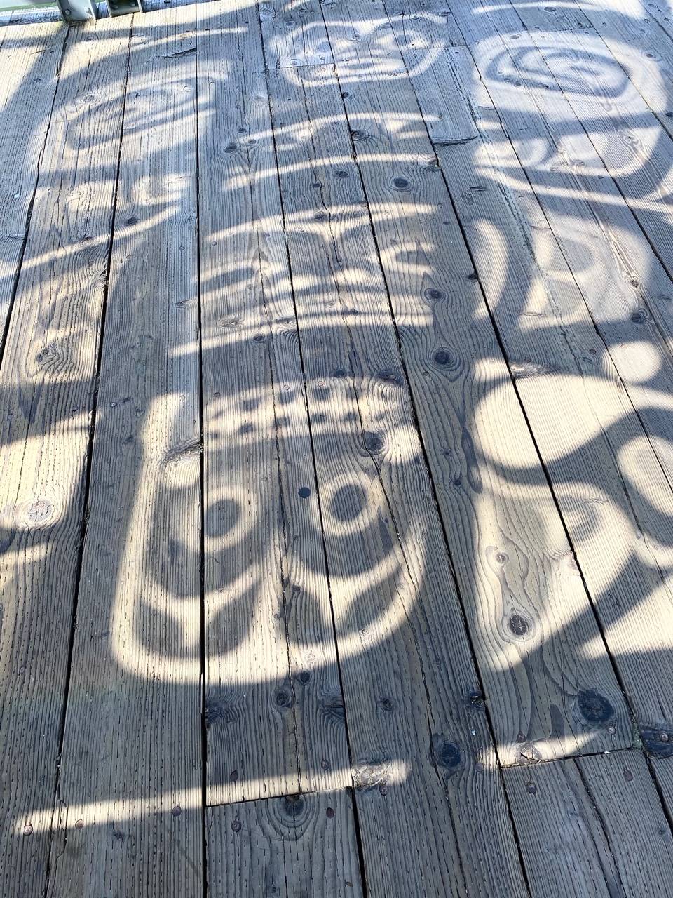 The sun, shines through a glass panel, duplicating the panel’s Tlingit design onto the downtown sea walk on July 28, 2020. (Courtesy Photo / Denise Carroll)