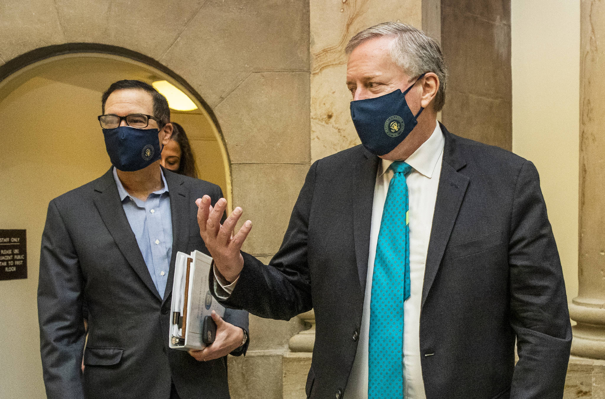 White House chief of staff Mark Meadows, right, and Treasury Secretary Steven Mnuchin, arrive at the office of House Speaker Nancy Pelosi at the Capitol to resume talks on a COVID-19 relief bill, Saturday, Aug. 1, 2020, in Washington. (AP Photo / Manuel Balce Ceneta)