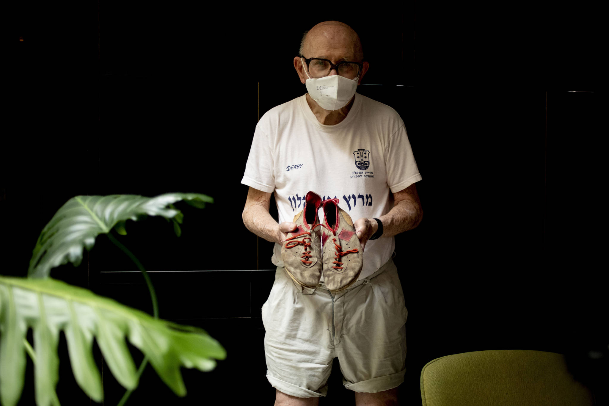 Israeli Olympic racewalker Shaul Ladany holds his 1972’s Olympic race shoes for a portrait in Omer, Israel, Sunday, July 12, 2020. In an instant, the world record holder in the 50-mile walk was thrust into one of sports’ greatest tragedies and a seminal moment in modern history _ the kidnapping and massacre of his fellow Israeli team members at the 1972 Munich Olympics. The killing shocked the world, gave the Palestinian cause an audience and ushered in a new era of global terrorism. Ladany, a Holocaust survivor, the lessons still linger. He says it taught him to “never be afraid” but become “more careful.”(AP Photo / Ariel Schalit)