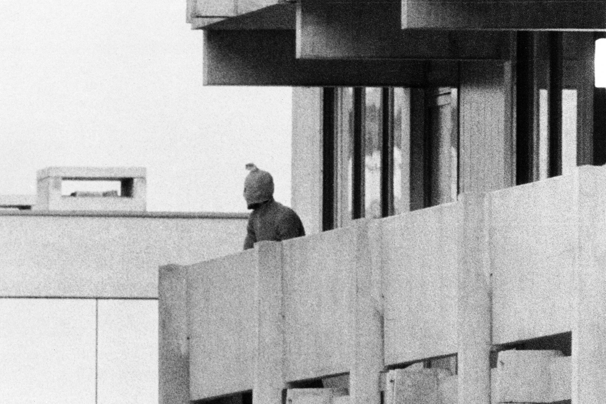 On Sept. 5, 1972, a Palestinian commando group seizes the Israeli Olympic team quarters at the Olympic Village in Munich, Germany. A member of the commando group is seen here as he appears with a hood over his face on the balcony of the building, where they hold several Israeli athletes hostage. (AP Photo / Kur Stumpf)