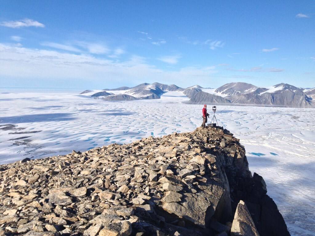 Luke Copland This July 2015 photo taken by University of Ottawa glaciology professor Luke Copland shows Canadian Ice Service ice analyst Adrienne White taking a photo of cracks of the Milne Ice Shelf, which just broke apart.