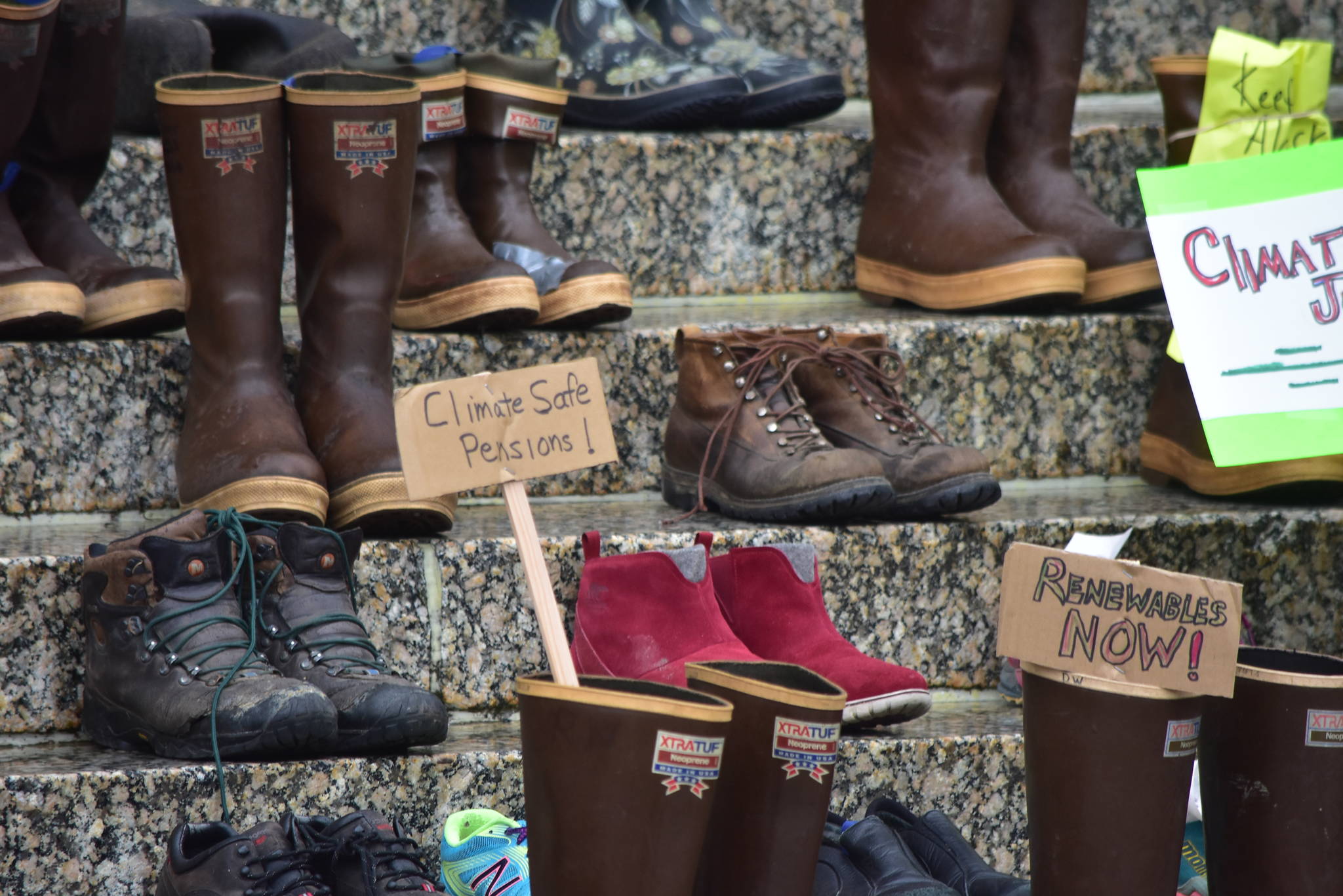 Environmental protestors with 350Juneau placed pairs of shoes on the steps of the Alaska State Capitol Wednesday, Aug. 12, 2020, to represent all the demonstrators who would’ve been there if not for the coronavirus pandemic. (Peter Segall / Juneau Empire)