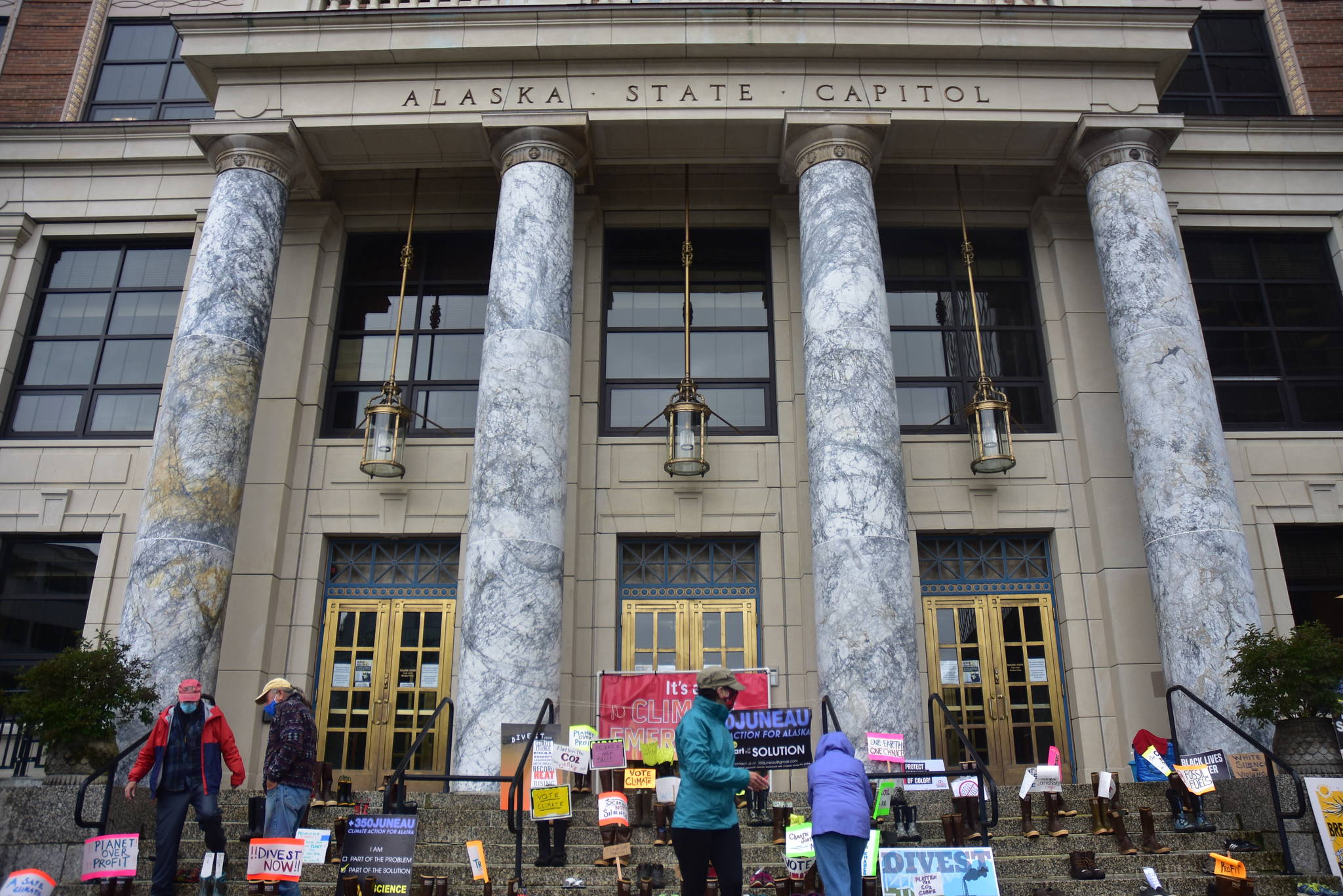 Environmental protestors with 350Juneau placed pairs of shoes on the steps of the Alaska State Capitol Wednesday, Aug. 12, 2020, to represent all the demonstrators who would’ve been there if not for the coronavirus pandemic. (Peter Segall / Juneau Empire)