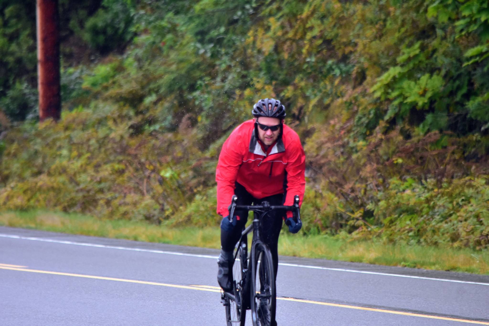 Cyclist Will Mitchell completes the first leg of the Tour of Juneau bike race on the North Douglas Highway on Friday, Aug. 14, 2020. (Peter Segall / Juneau Empire)