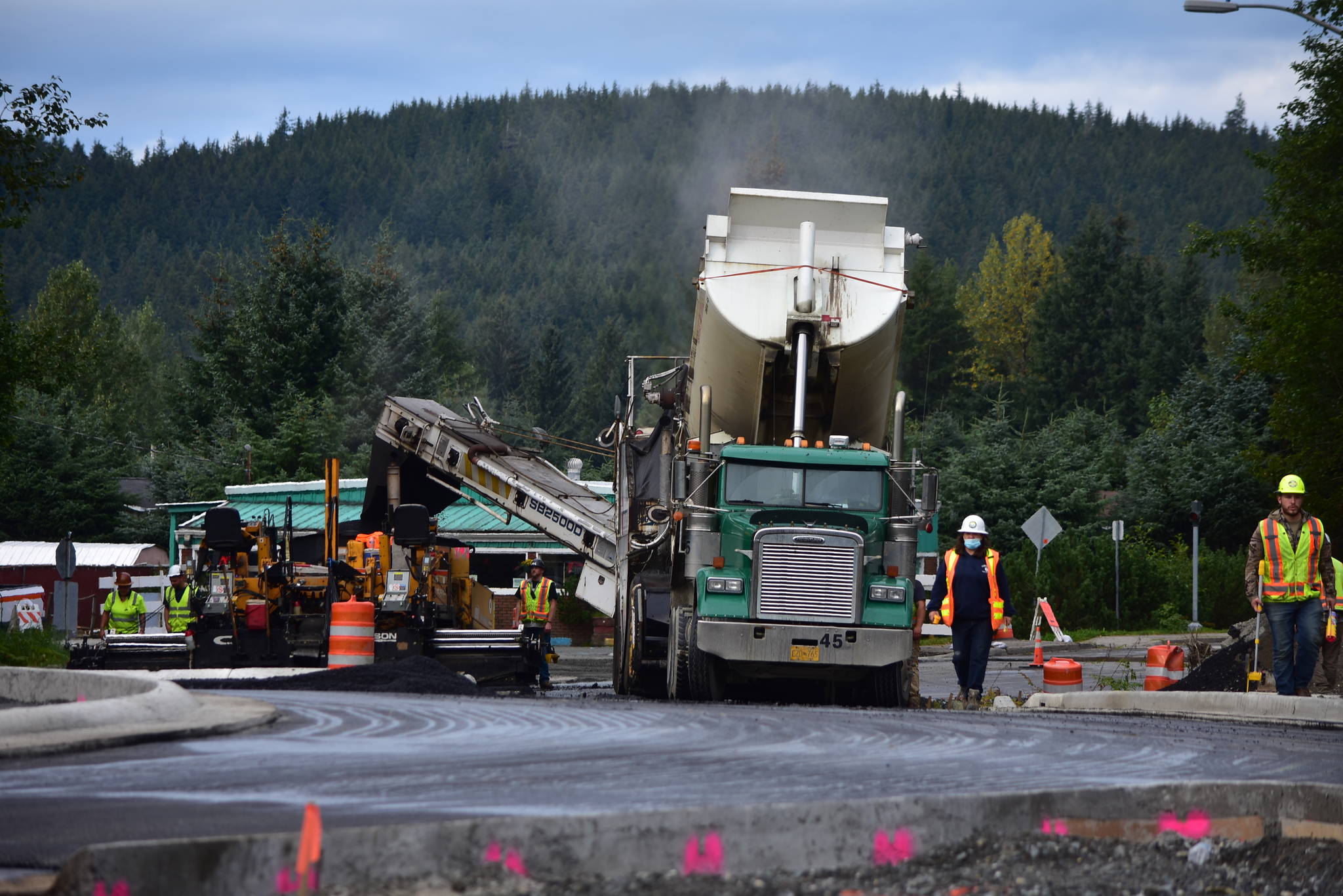 A dump truck empties its payload at a construction site on Mendenhall Loop Road and Steven Richards Memorial Drive where the Department of Transportation and Public Facilities is building a roundabout on Tuesday, Aug. 20, 2020. (Peter Segall / Juneau Empire)