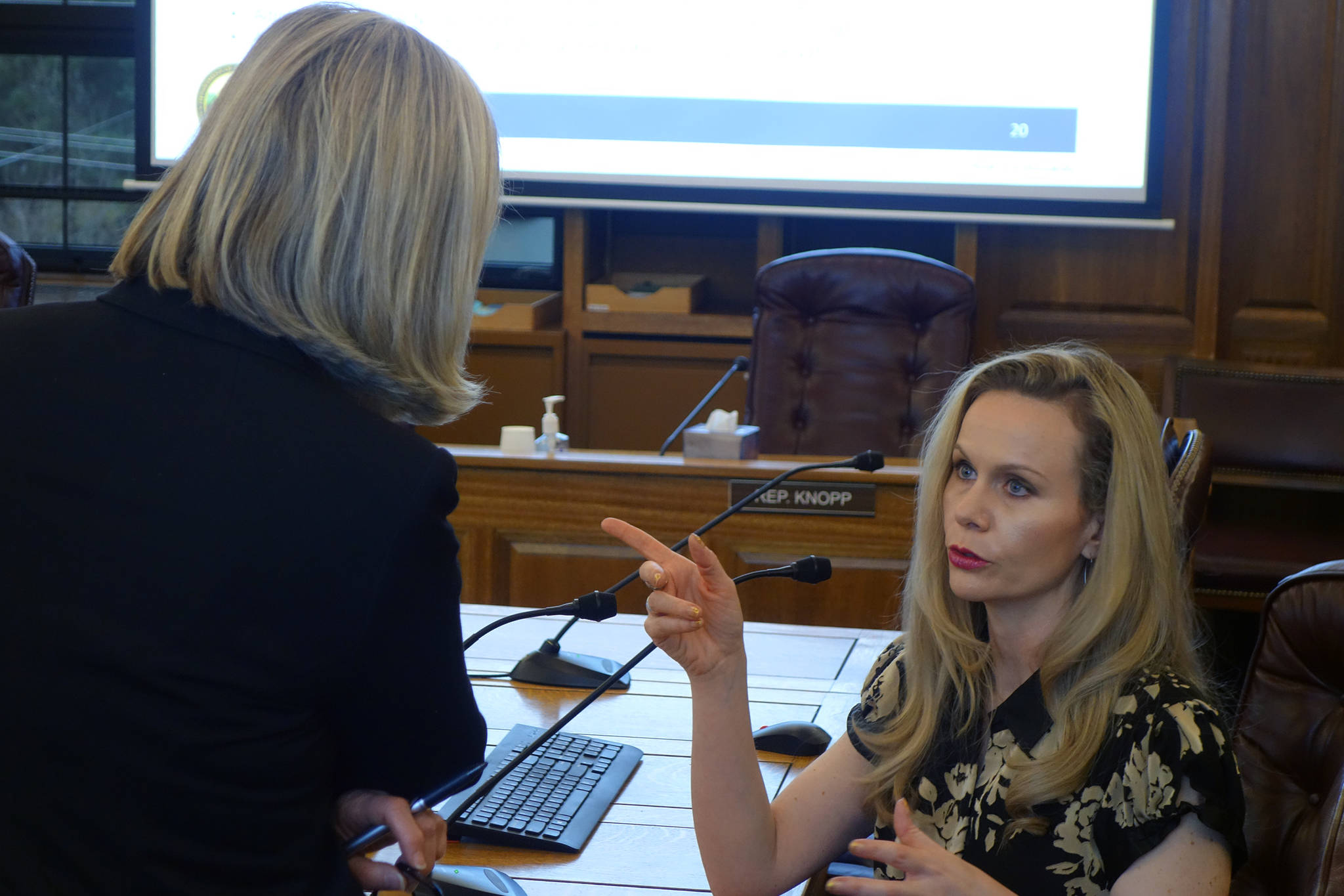 Rep. Andi Story, D-Juneau, talks with Department of Administration Commissioner Kelly Tshibaka following a House Administration Committee Finance Subcommittee meeting in this January 2020 photo. (Ben Hohenstatt / Juneau Empire File)