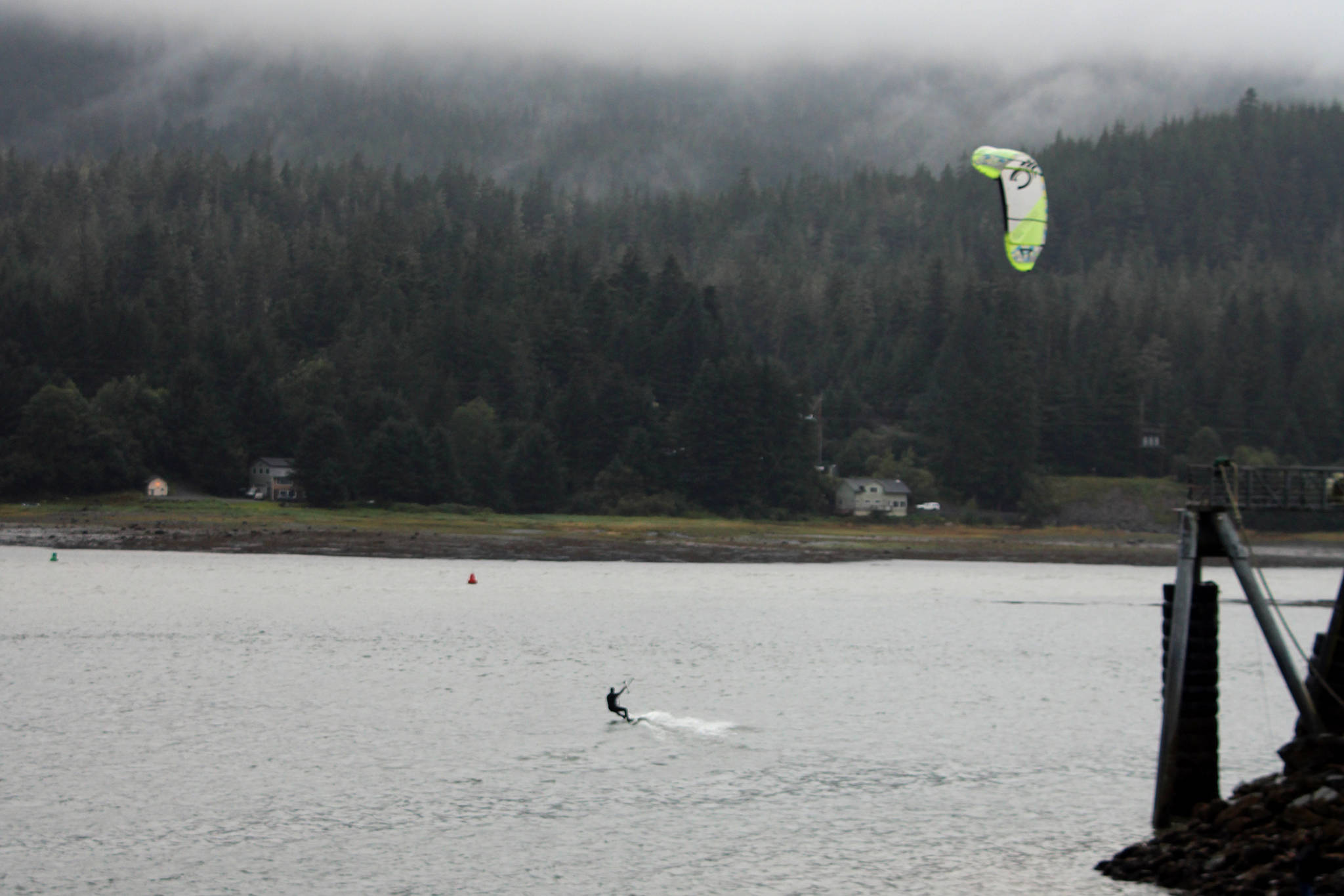 A kiteboarder practices their hobby in spite of dreary weather as Juneau’s third wettest summer on record comes to a damp end, Sept. 3, 2020. (Ben Hohenstatt / Juneau Empire)