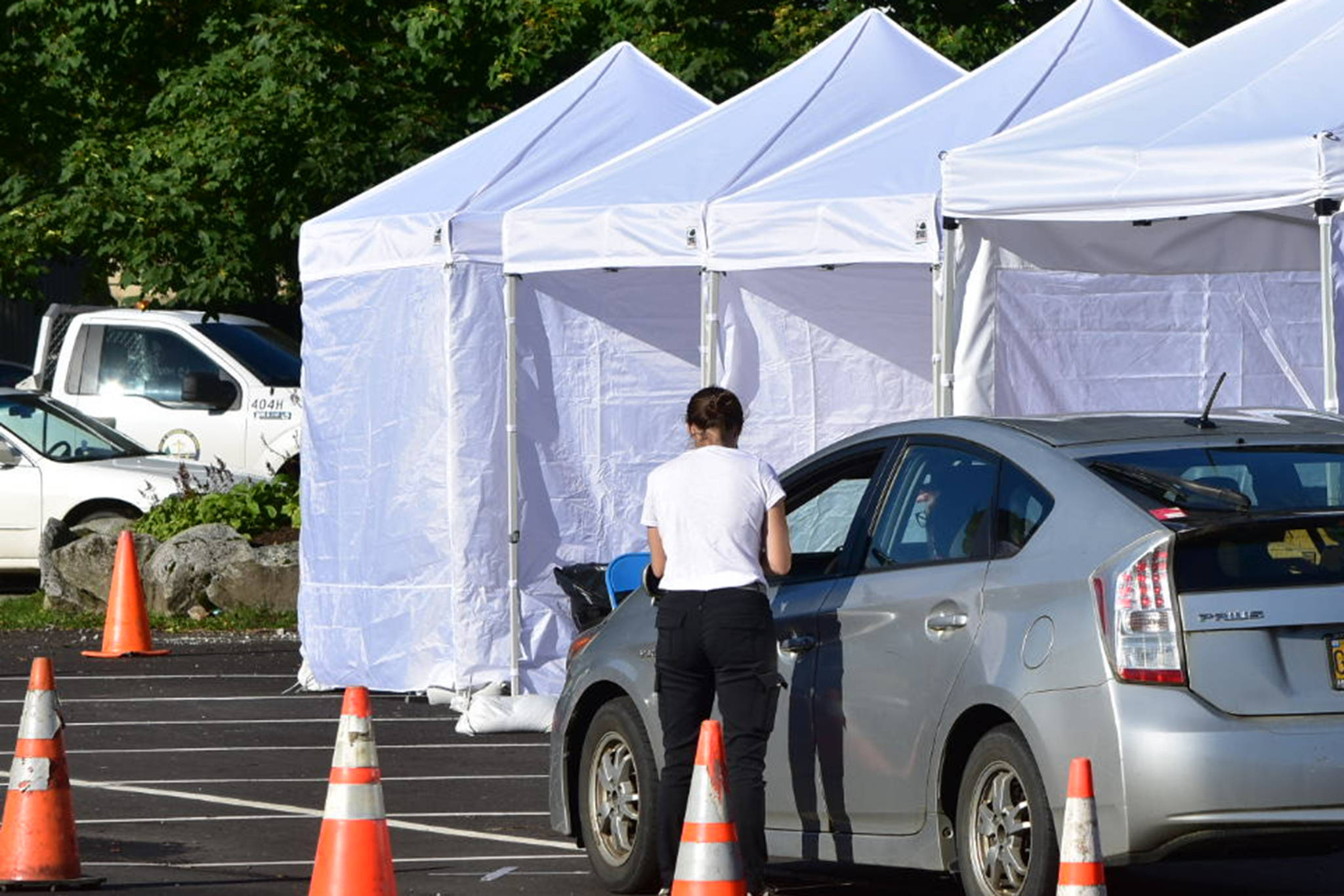 A screener talks to a driver at a temporary testing site outside Centennial Hall. The City and Borough of Juneau set up additional testing centers in the parking lot of Centennial Hall in downtown Juneau on Thursday, Sept. 10, 2020. Additional sites were needed to meet high demand for testing following a advisory earlier in the week. (Peter Segall / Juneau Empire)