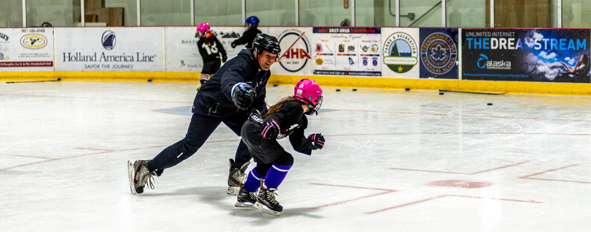 Youth hockey coach Randy Host plays freeze tag with a player competing in the 8-and-under age group. It’s a favorite activity for this age group.