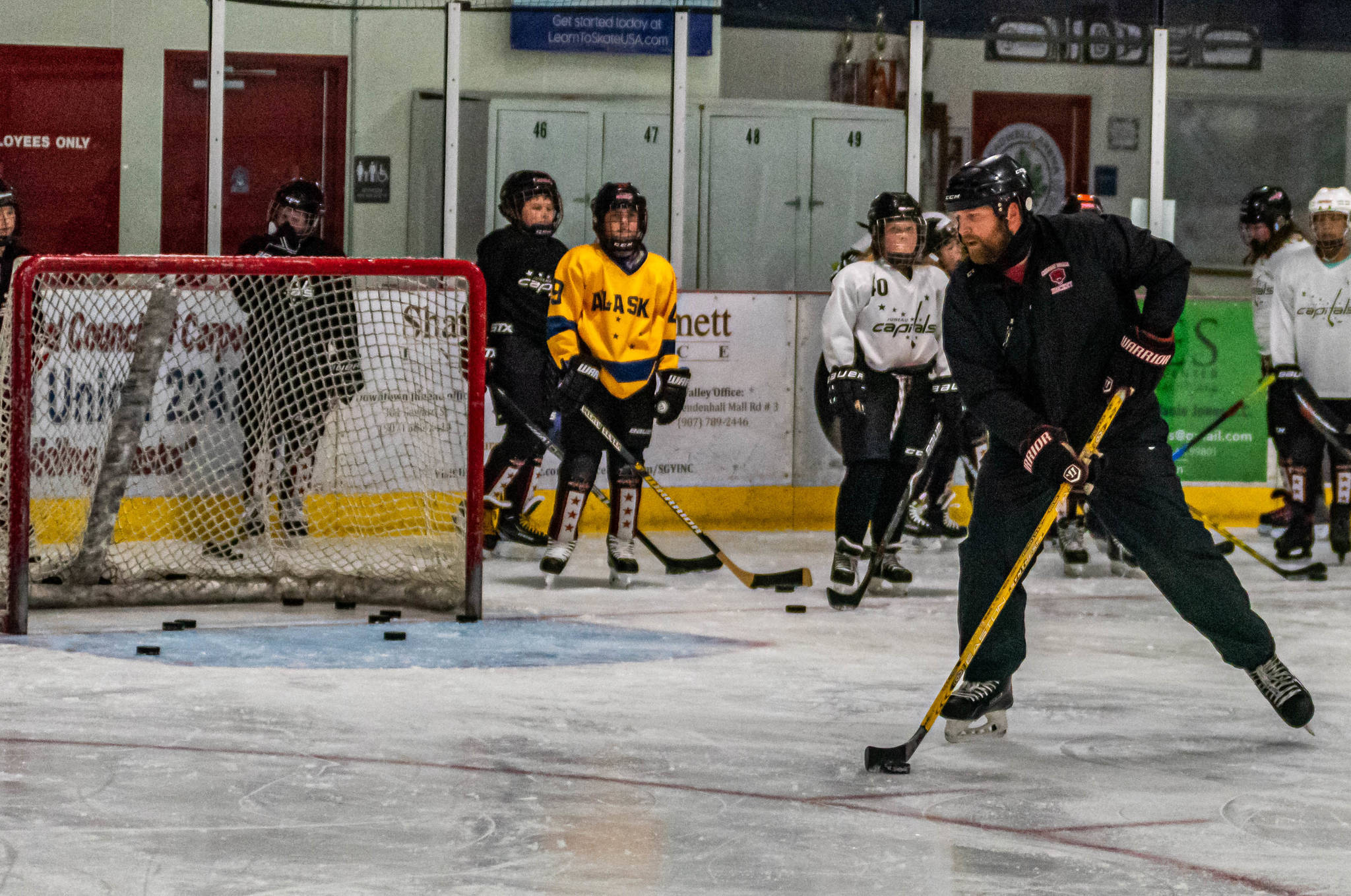 Matt Boline demonstrates a drill during a recent workout with players in the 12-and-under group workout at Treadwell Ice Arena. (Courtesy Photo / Steve Quinn)