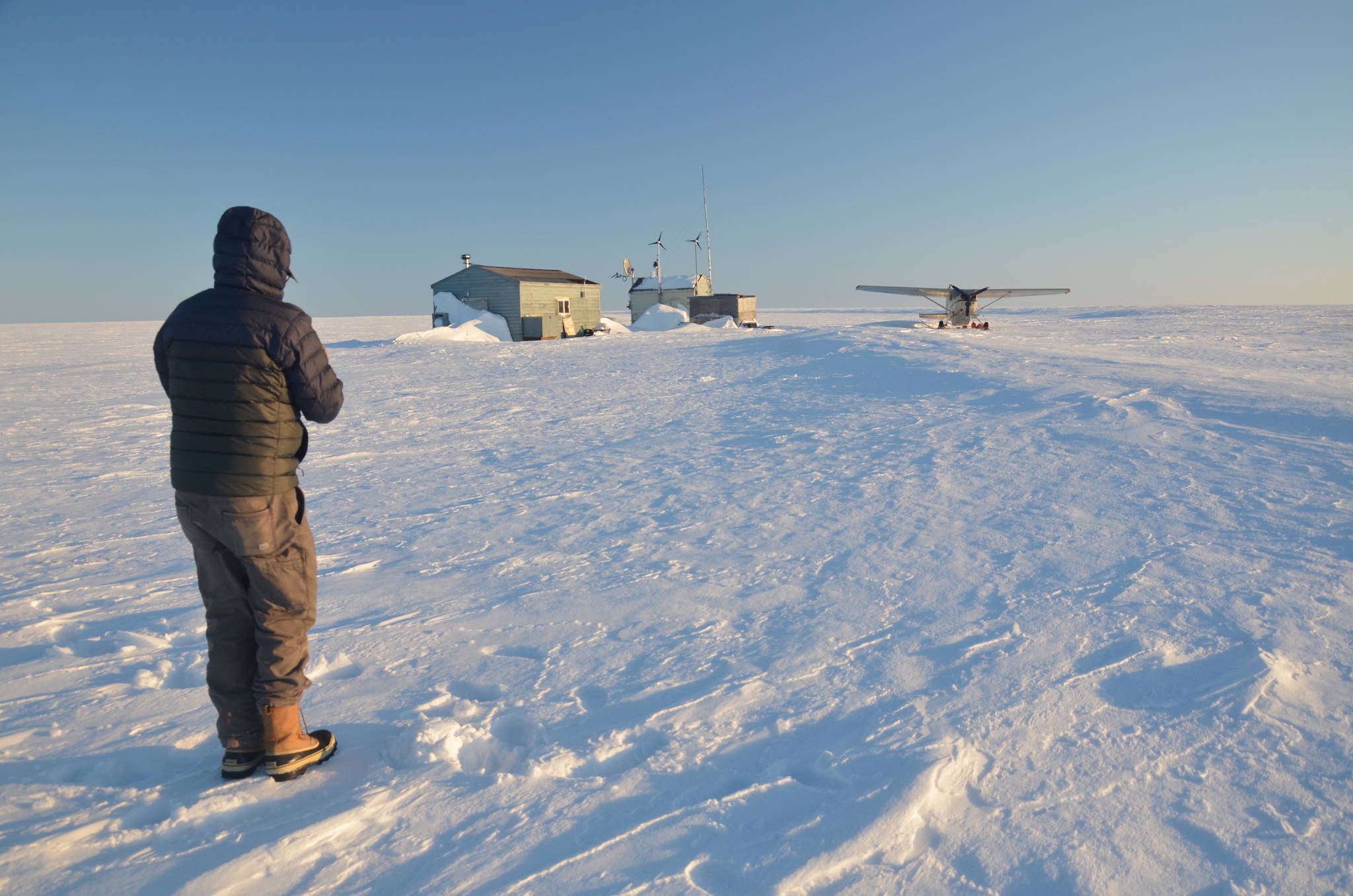 Jim Webster and his plane near a cabin on Teshekpuk Lake in northern Alaska. (Courtesy Photo / Ben Jones)