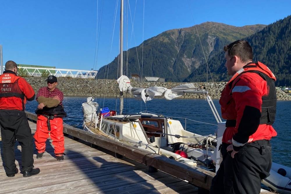 Several Coast Guard Station Juneau 45-foot Response Boat-Medium crew members speak with the owner of a disabled 22-foot sailing vessel after towing it from Marmion Island to Mike Pusich Douglas Harbor in Juneau, Sept. 13, 2020. (Courtesy Photo/Petty Officer 2nd Class Anthony DeLorenzo)