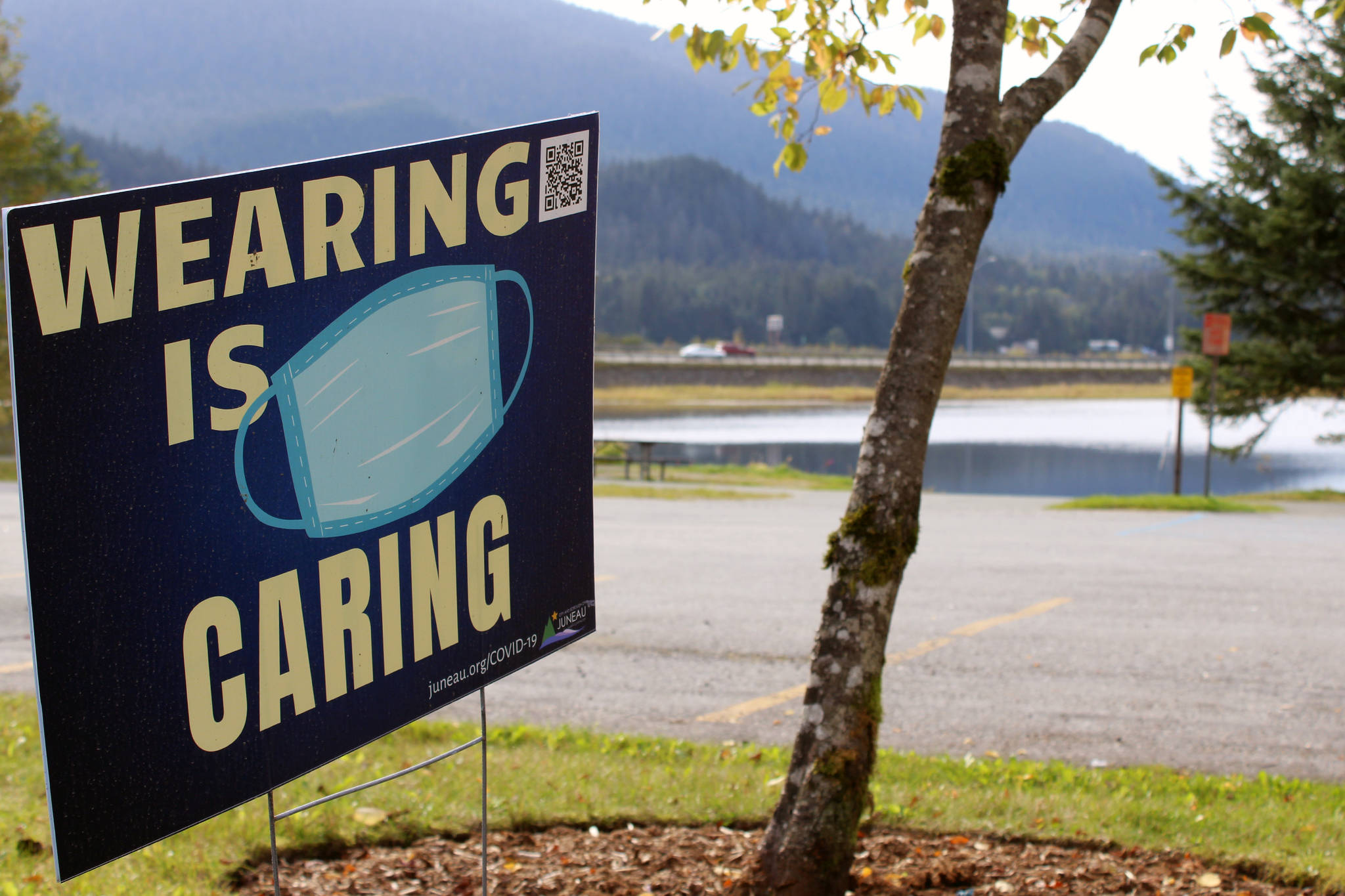 A sign seen near Twin Lakes on Wednesday encourages residents to wear cloth face coverings while in public. A social gathering tied to a recent cluster of cases of COVID-19 is unlikely to lead to punishment, but city officials are hopeful it may encourage people to be more cautious. Ben Hohenstatt / Juneau Empire