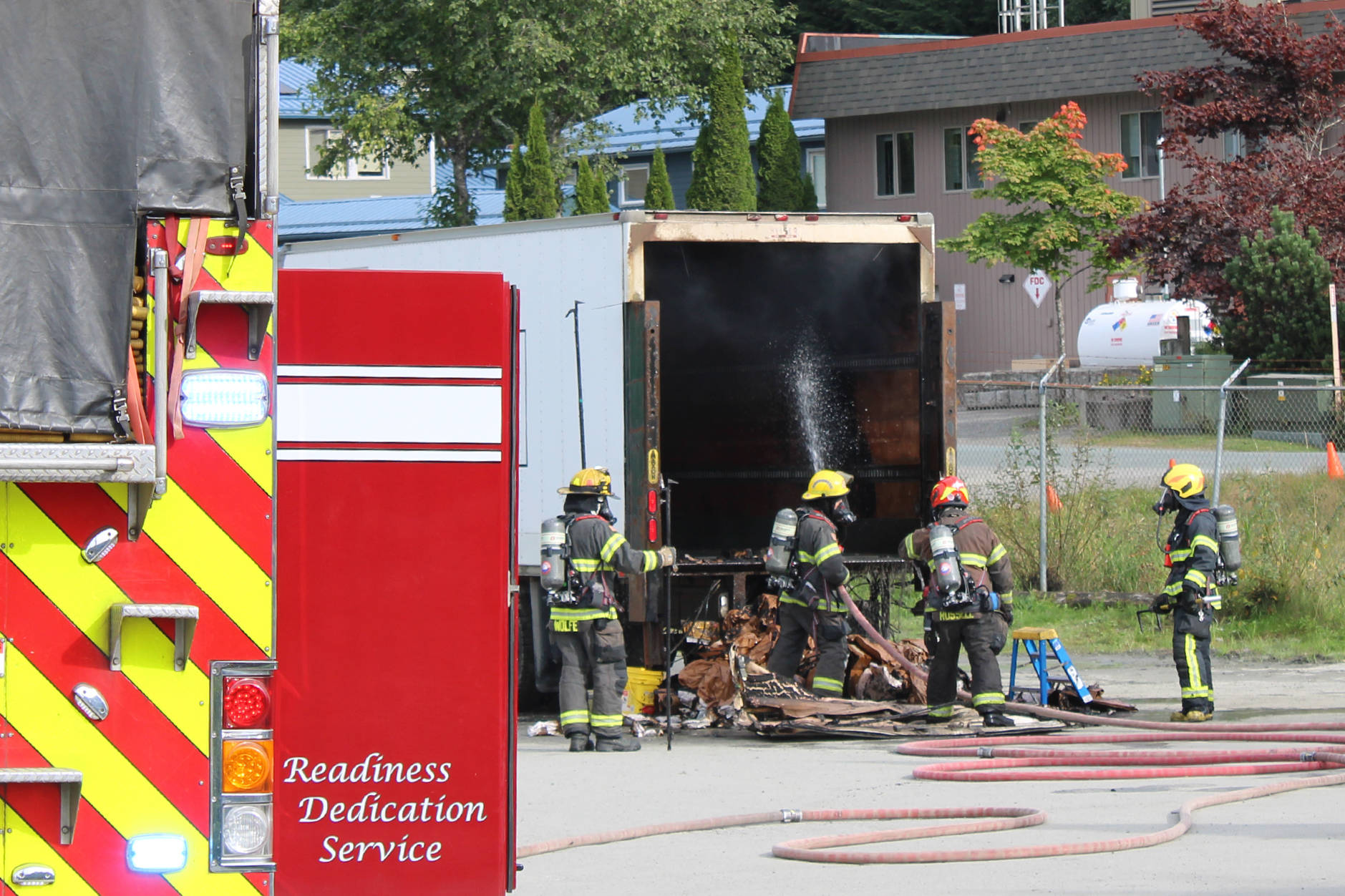 Firefighters spray the inside of a moving truck with water at the scene of a short vehicle fire on Sept. 17, 2020. (Ben Hohenstatt / Juneau Empire)