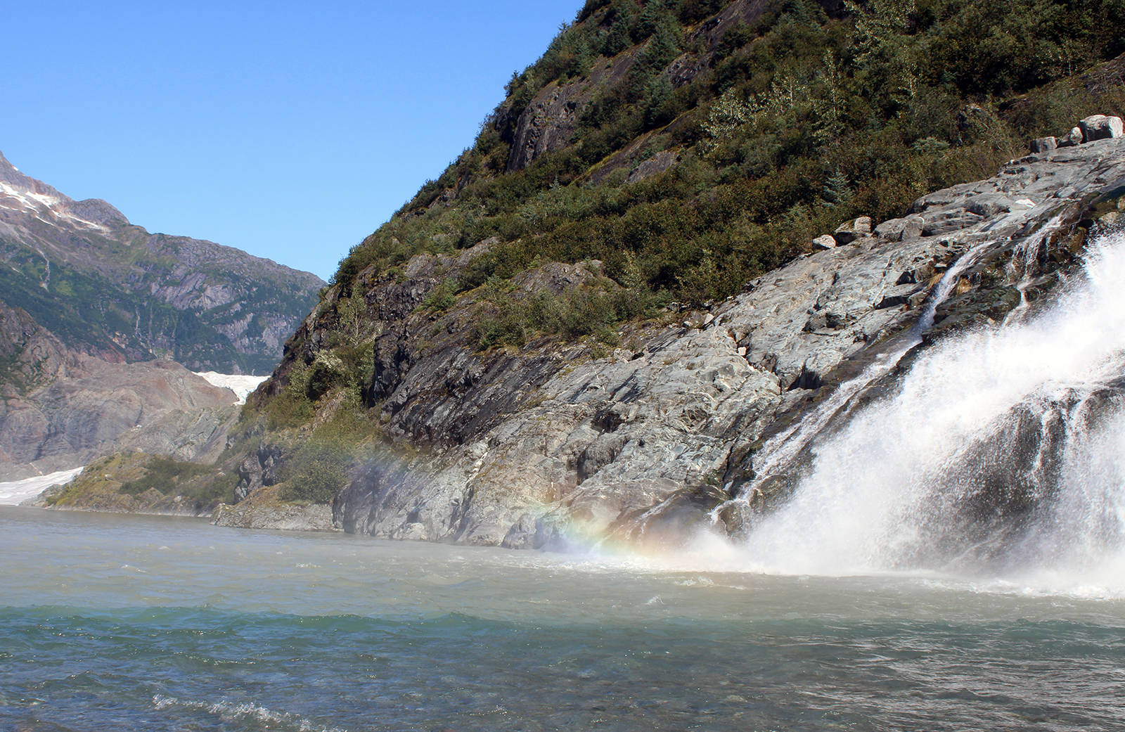 This Sept. 6, 2020, photo shows mist from Nugget Falls refracting light to create a prism-like effect. Like many children I watched this summer, mine enjoyed climbing the glacially smoothed rock slopes up to the visitor center or down to the water at Photo Point. And hiking to Nugget Falls, writes columnist Rich Moniak. (Ben Hohenstatt / Juneau Empire)