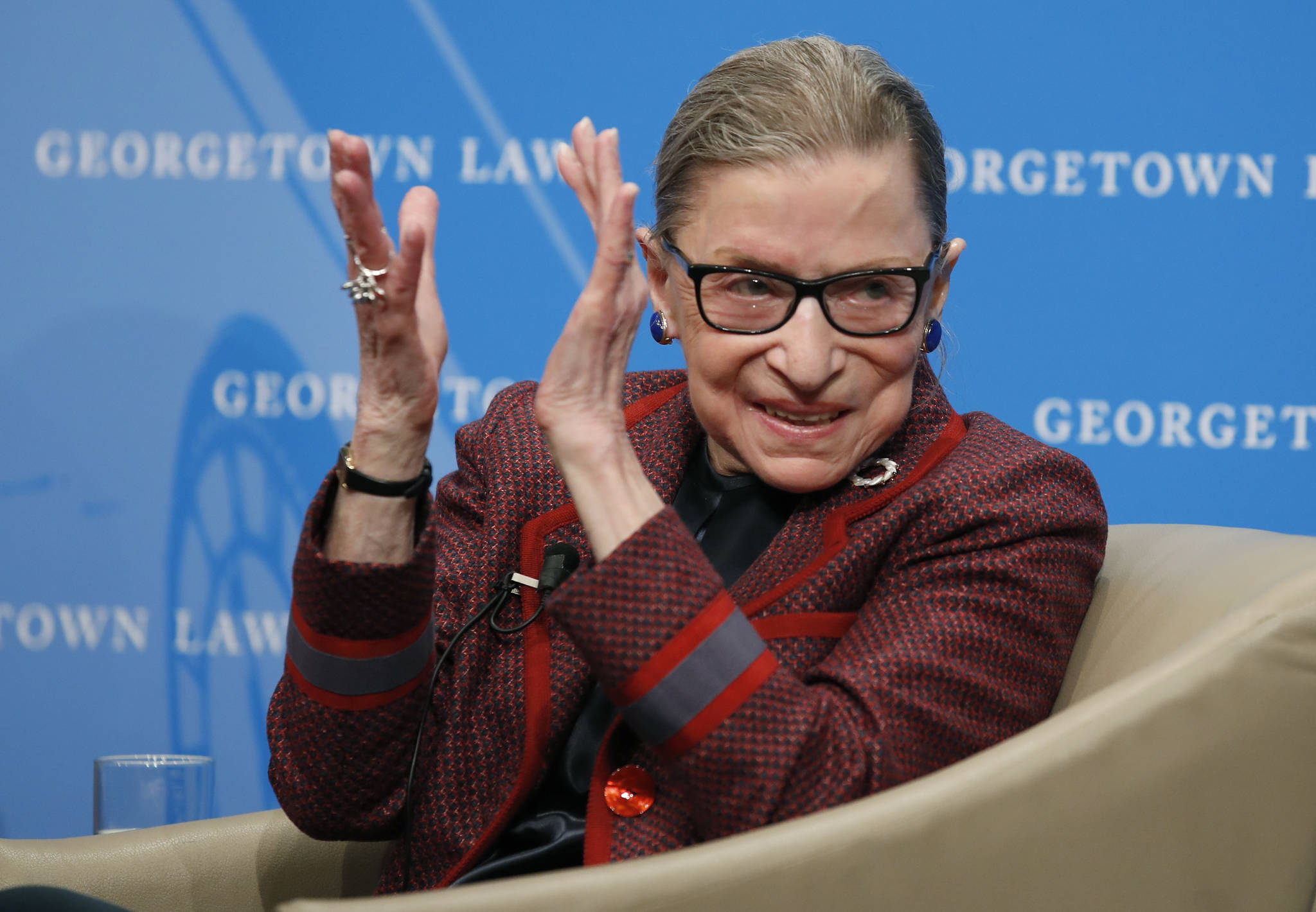 Supreme Court Justice Ruth Bader Ginsburg applauds after a performance in her honor after she spoke about her life and work during a discussion at Georgetown Law School in Washington in April 2018. The Supreme Court says Ginsburg has died of metastatic pancreatic cancer at age 87. (AP Photo/Alex Brandon)