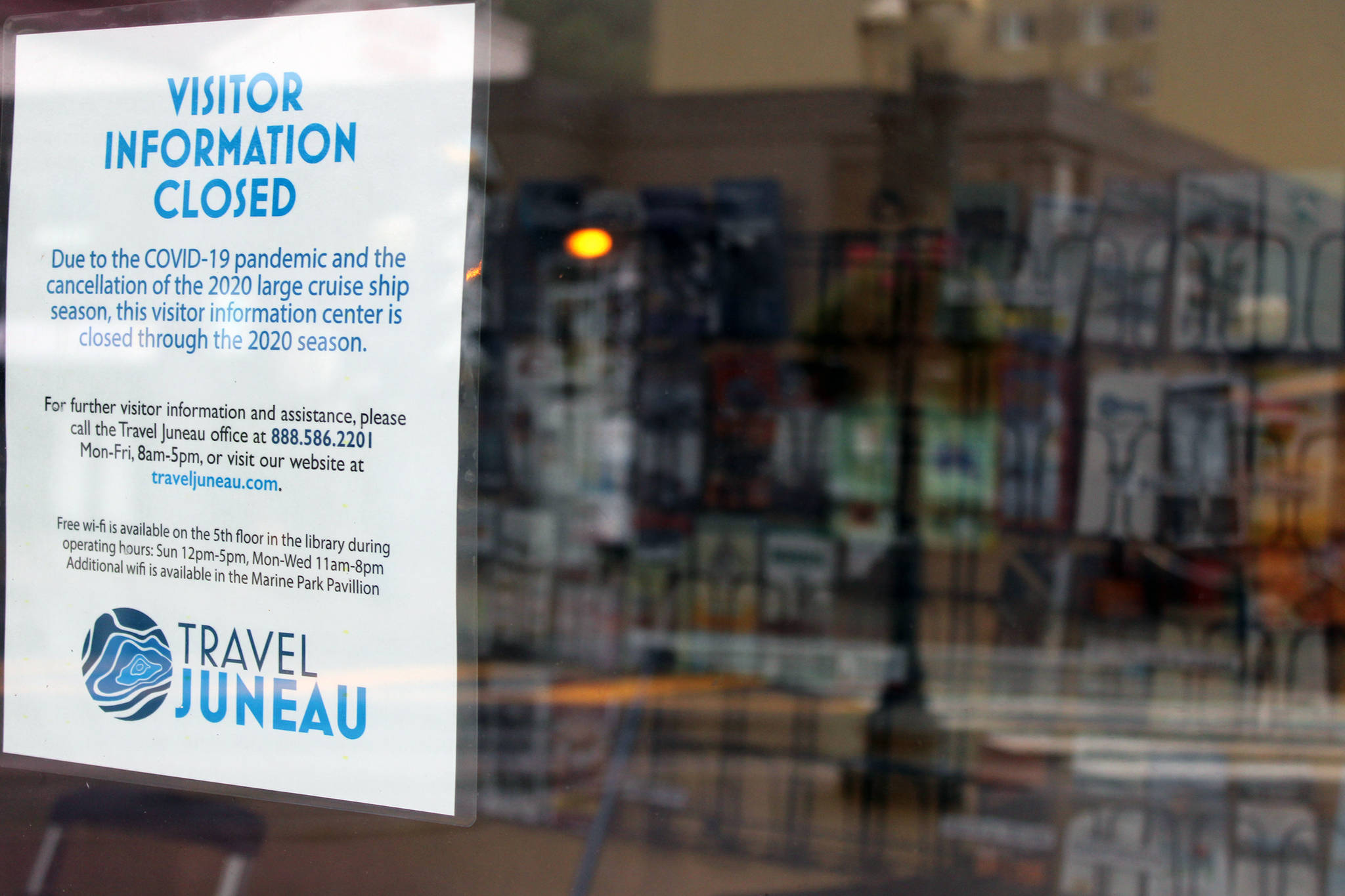 A sign posted by Travel Juneau notes the pamphlet-filled visitor’s center kiosk is closed because of the pandemic. The center, located near the downtown library, opened in May 2019 during Infrastructure Week. (Ben Hohenstatt / Juneau Empire)