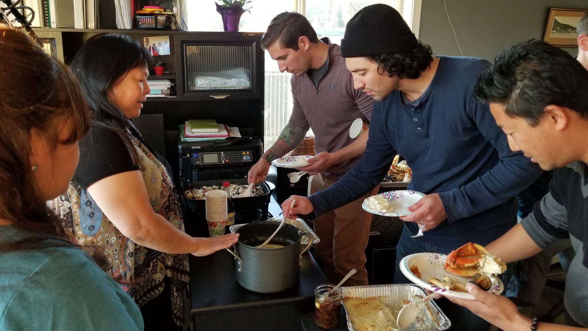 Members of the Xbox and Dontnod Entertainment team load up their plates with food during a visit to Hoonah. The Southeast Alaska village, Huna Heritage Foundation and Hoonah-based artists helped inspire the setting of the game “Tell Me Why.” Chapters of the episodic narrative adventure game were released in August and September. (Courtesy Photo / Xbox)