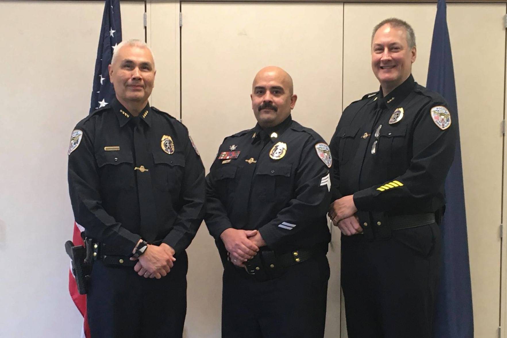 Juneau Police Department Chief Ed Mercer, left, and Deputy Chief David Campbell, right, pose with Sgt. Nick Garza, center, for Garza's promotion to sergeant on Oct. 14, 2020. (Courtesy photo / JPD)