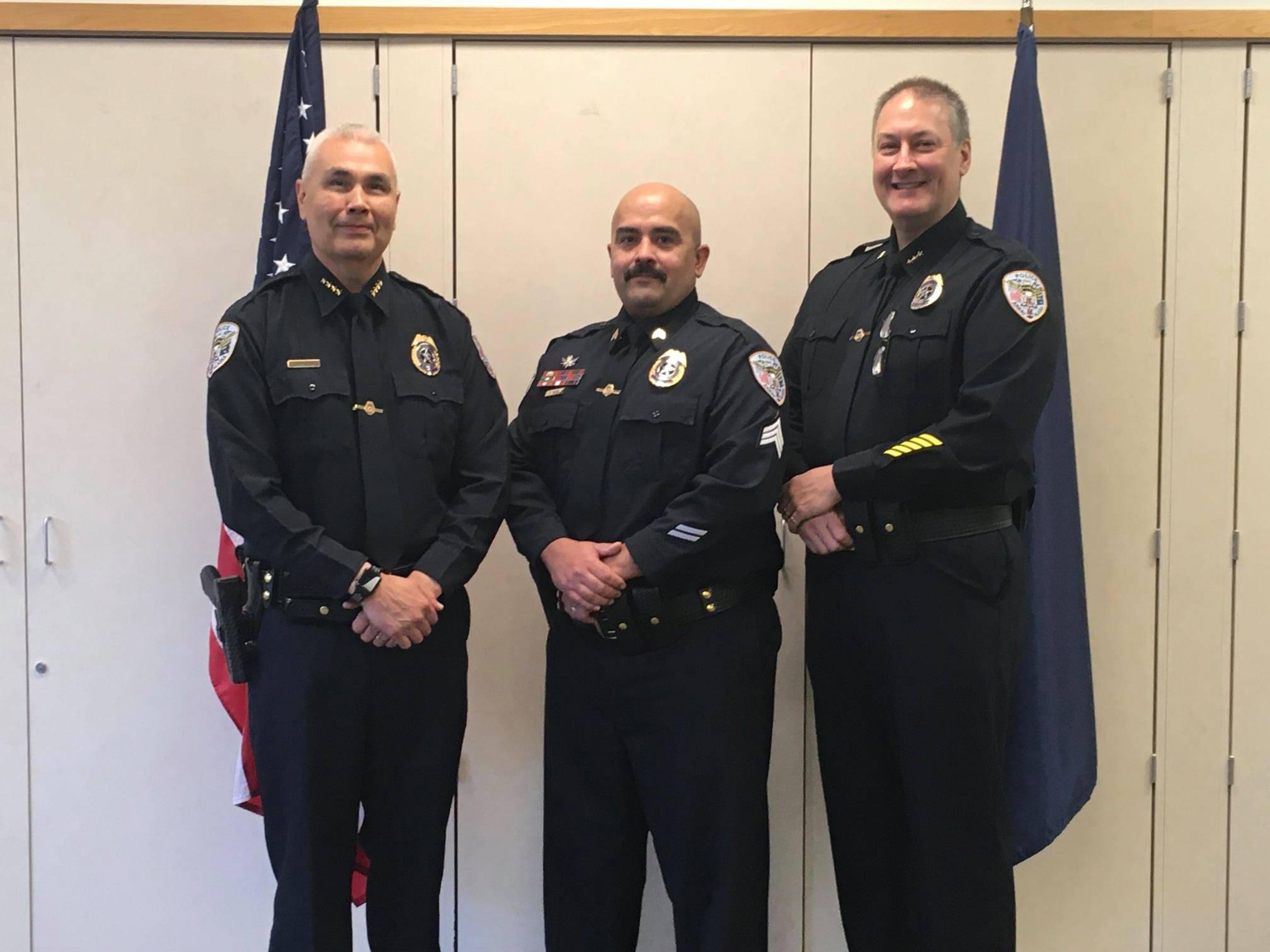 Juneau Police Department Chief Ed Mercer, left, and Deputy Chief David Campbell, right, pose with Sgt. Nick Garza, center, for Garza's promotion to sergeant on Oct. 14, 2020. (Courtesy photo / JPD)