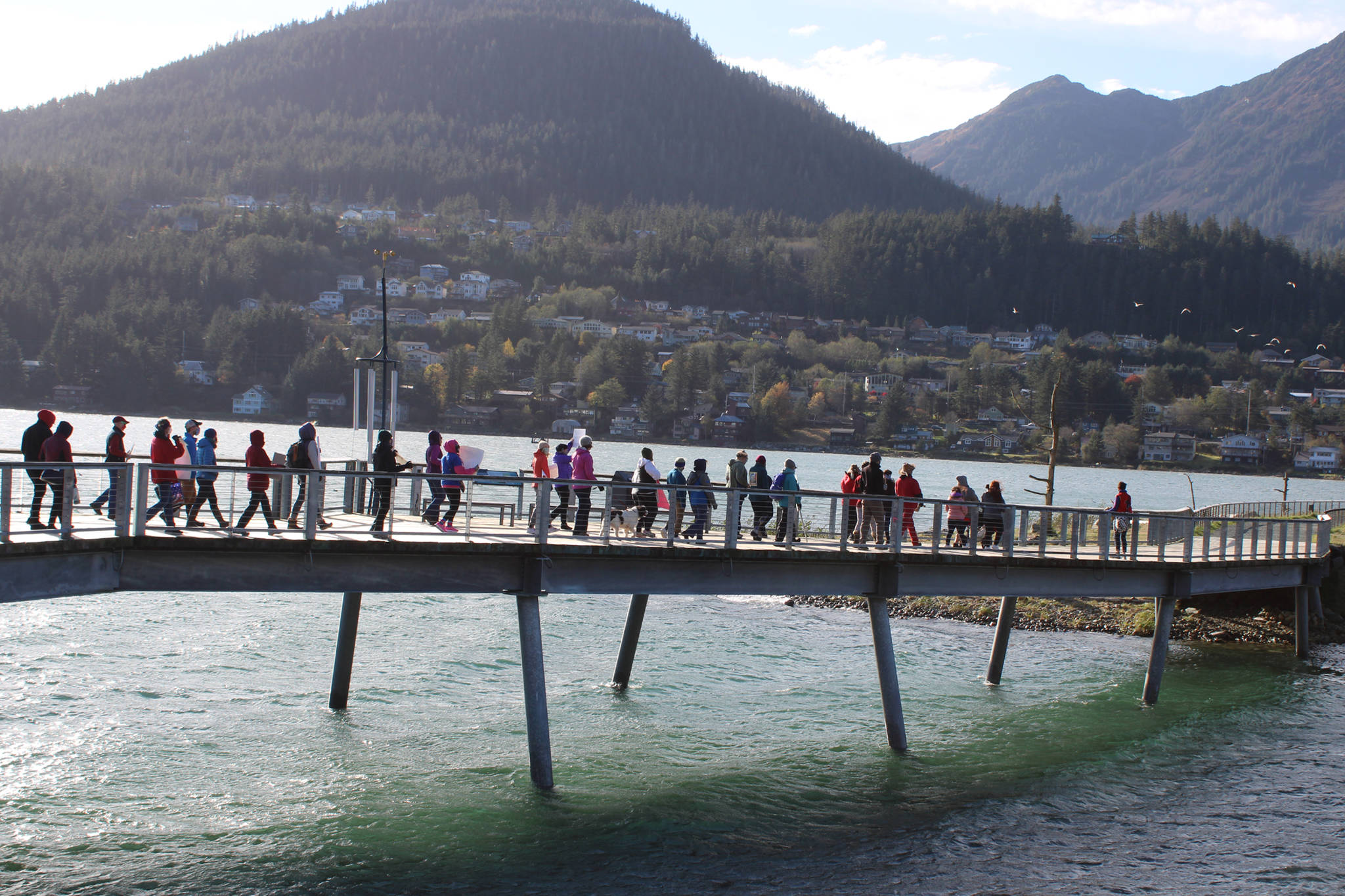 Rather than walk on the sidewalk the whole way to Mayor Bill Overstreet Park, participants in Saturday’s women’s march walked some of the way their via the Seawalk. (Ben Hohenstatt Juneau Empire)