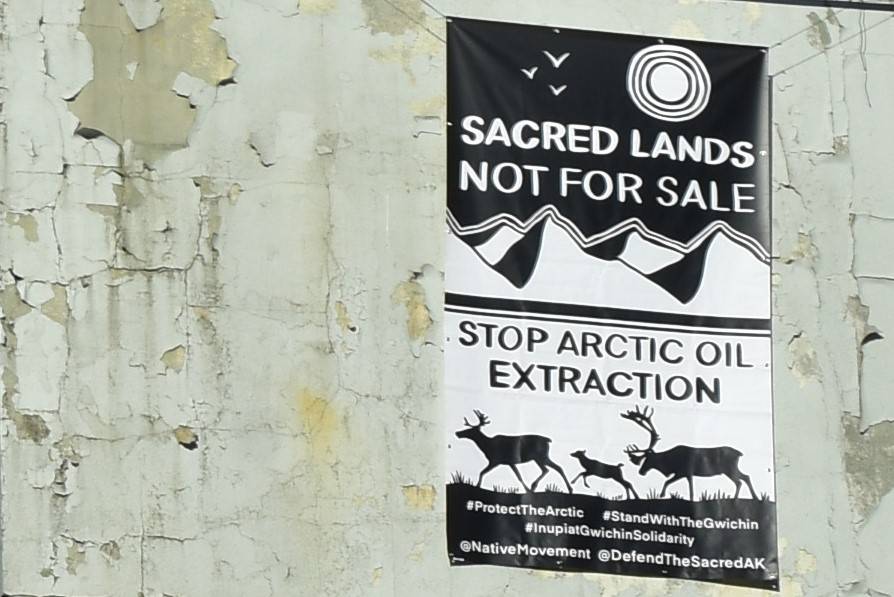 A banner protesting resource extraction in the Arctic was hung from a building in downtown Juneau on Wednesday, Oct. 21, 2020. On social media, activists posted photos of the banner in cities around the state and nation, and even as far away as London. (Peter Segall / Juneau Empire)