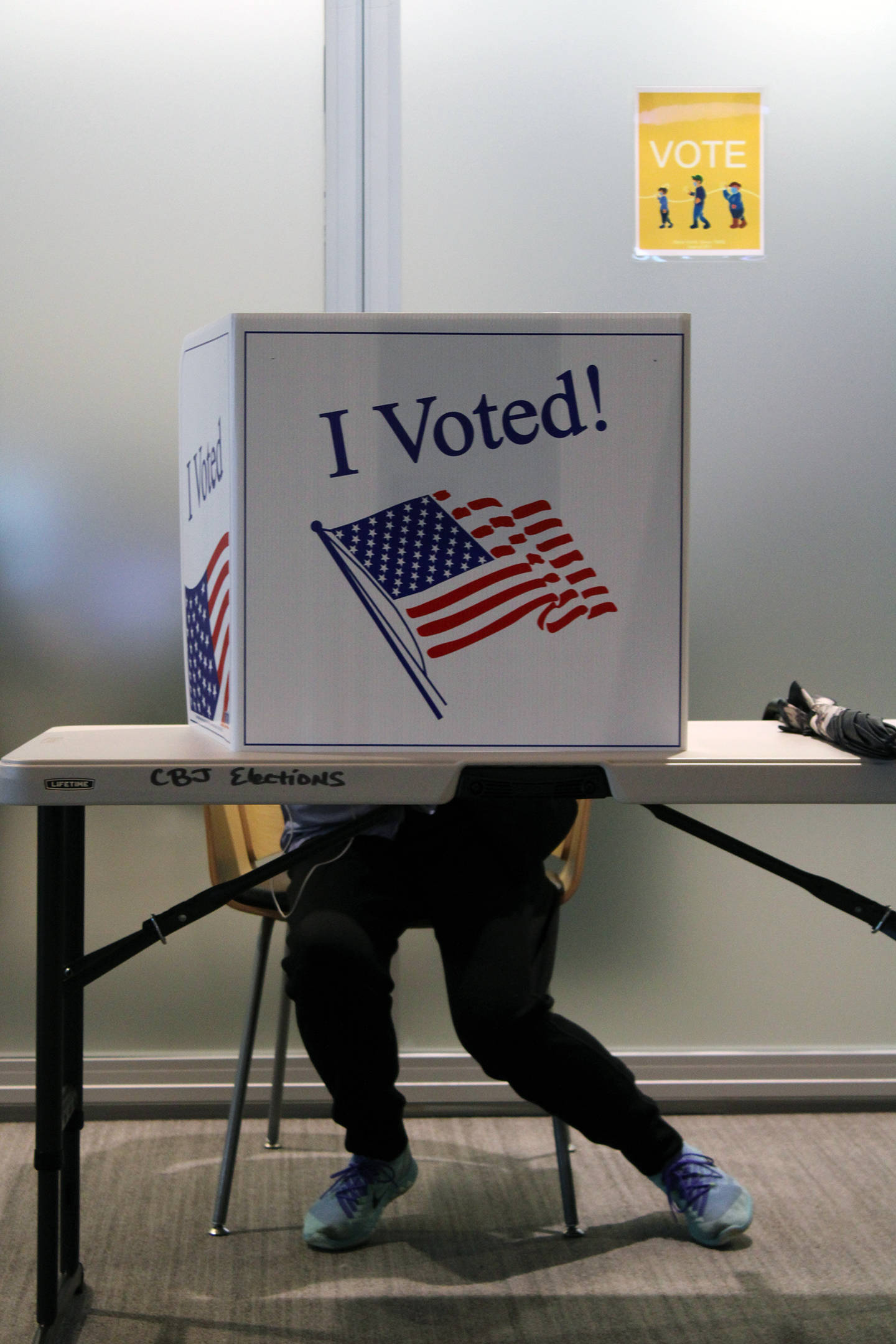 A voter fills out their ballot in person at the Mendenhall Valley Public Library on Oct. 6, 2020. The library was the site of one of the voting centers during the City and Borough of Juneaus by-mail municipal election. In the upcoming general election, Ballot Measure 2 will be on ballots in Alaska. (Ben Hohenstatt / Juneau Empire File)