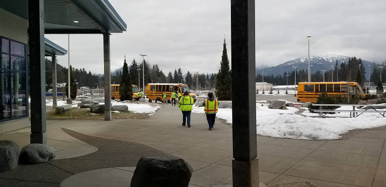 First Student employees load meals on school buses so the meals can be distributed to Juneau youths. (Courtesy Photo / Juneau School District)