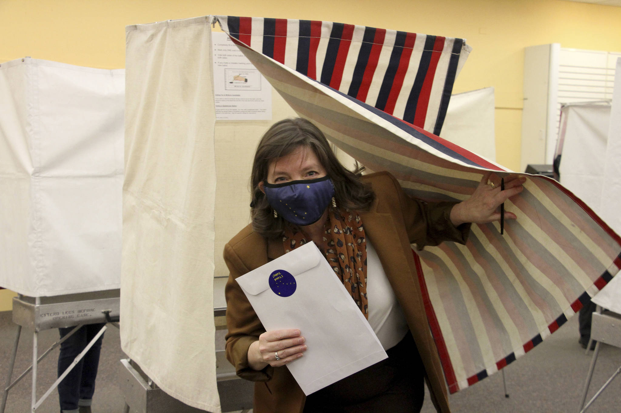 Alyse Galvin emerges from the voting booth after casting her early vote Friday, Oct. 30, 2020, in Anchorage, Alaska. Galvin, an independent, is trying to unseat U.S. Rep. Don Young, Alaska’s sole member of the U.S. House and in office since 1973. (AP Photo / Mark Thiessen)