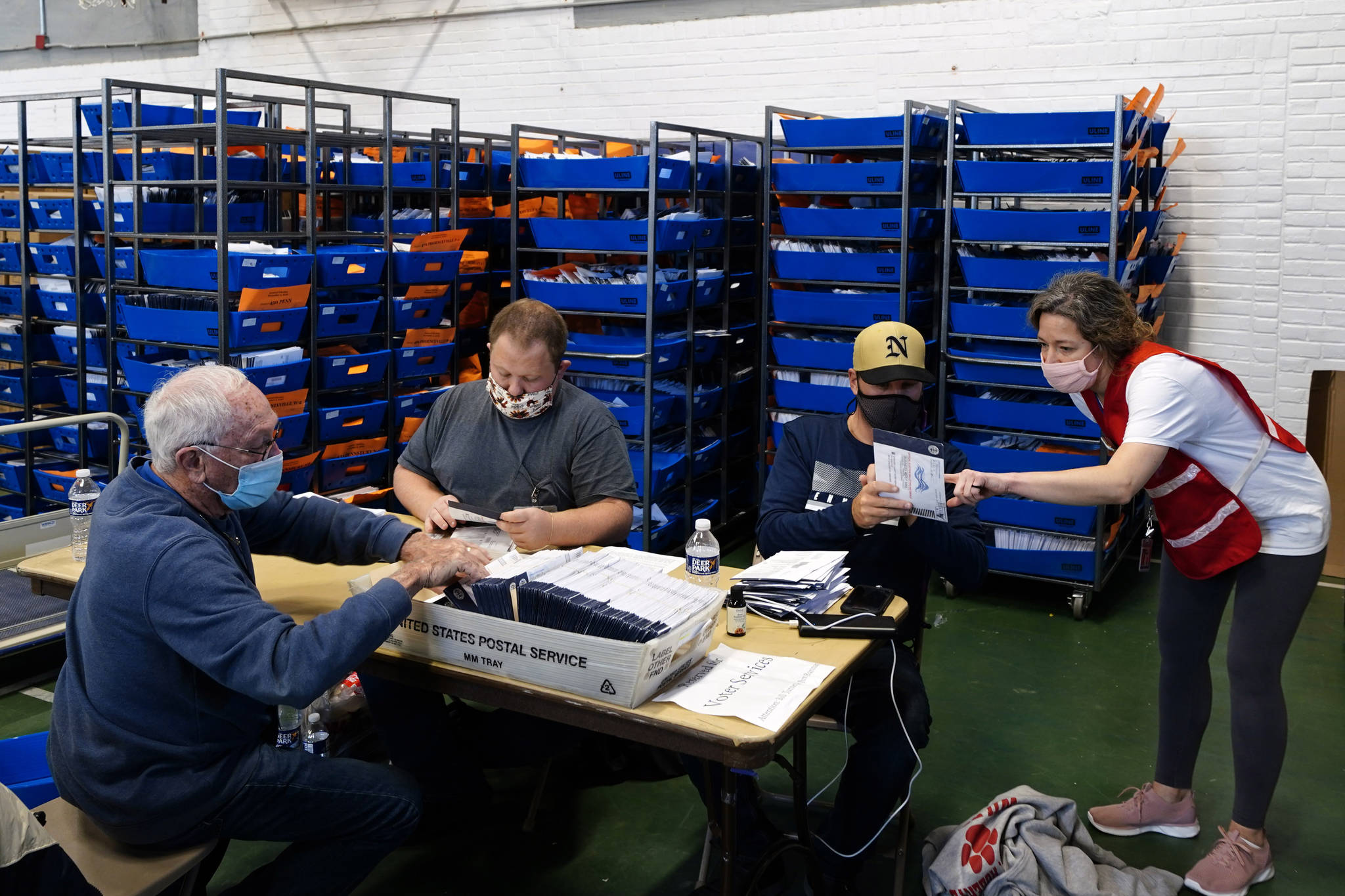 Chester County, Pa. election workers process mail-in and absentee ballots for the 2020 general election in the United States at West Chester University, Wednesday, Nov. 4, 2020, in West Chester, Pa. (AP Photo/Matt Slocum)