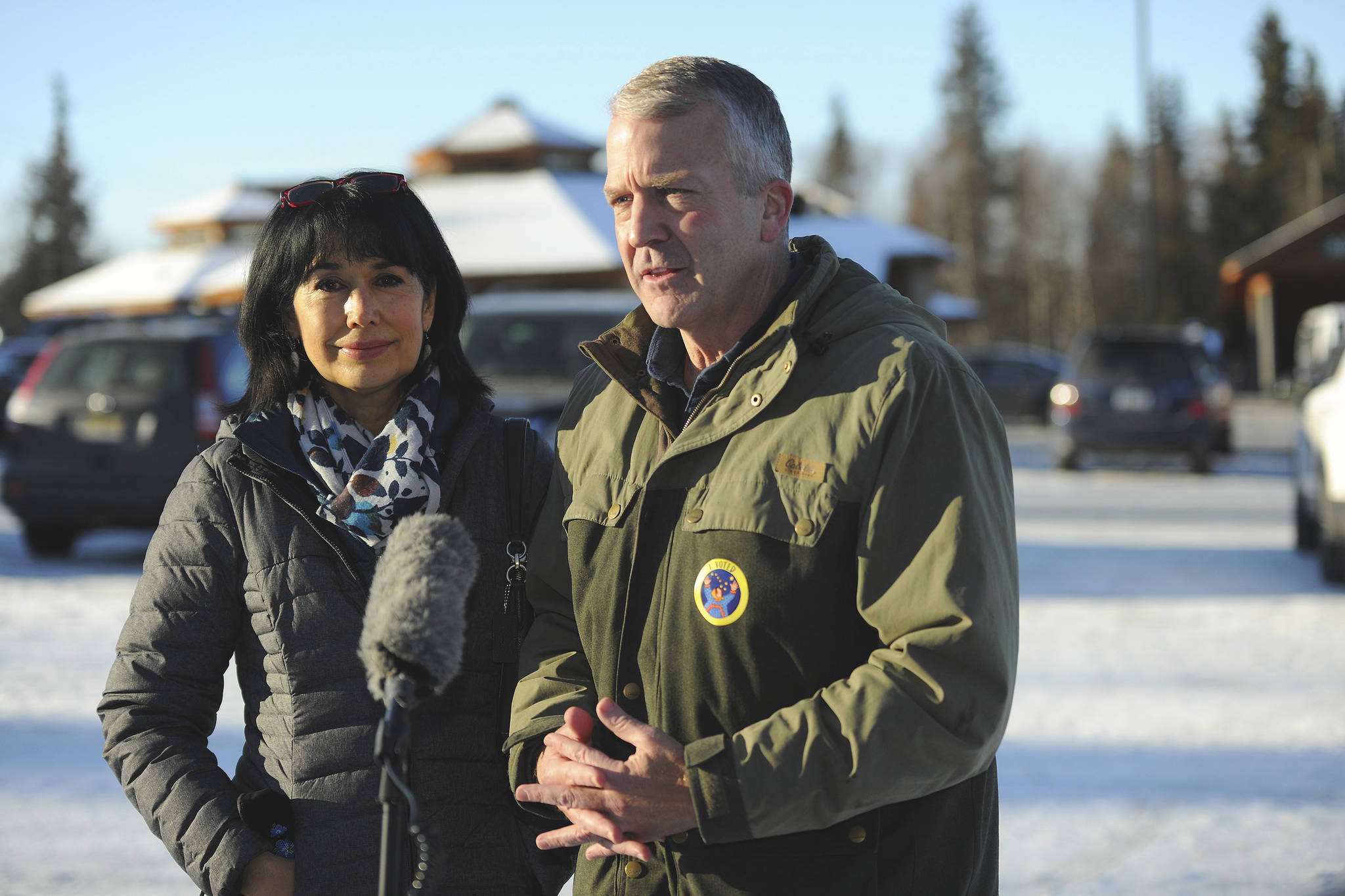 Incumbent Republican Sen. Dan Sullivan, left, with his wife Julie, speaks to the media after casting his ballot at the Alaska Zoo Tuesday, Nov. 3, 2020 in Anchorage, Alaska. (AP Photo / Michael Dinneen)