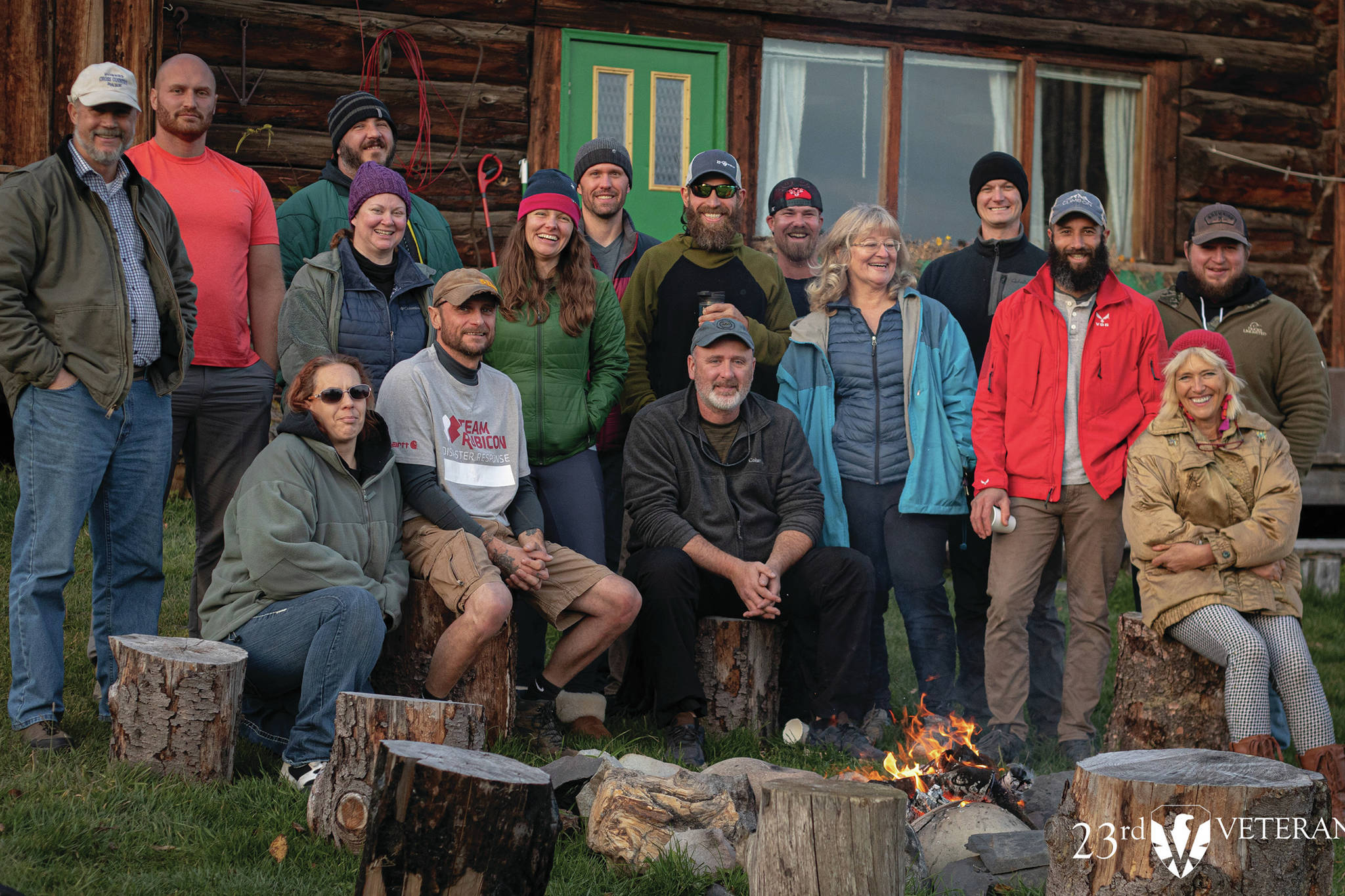 A group of veterans who participated in the 23rd Veteran trip to Homer, Alaska, pose at the Kilcher Family Homestead near Homer, Alaska, on the last day of the trip on Friday, Oct. 16, 2020. At far right, front, is Stellavera Kilcher, and third from right is Catkin Kilcher Burton, two of the Kilcher family members who participated in the visit. (Courtesy Photo / 23rd Veteran)