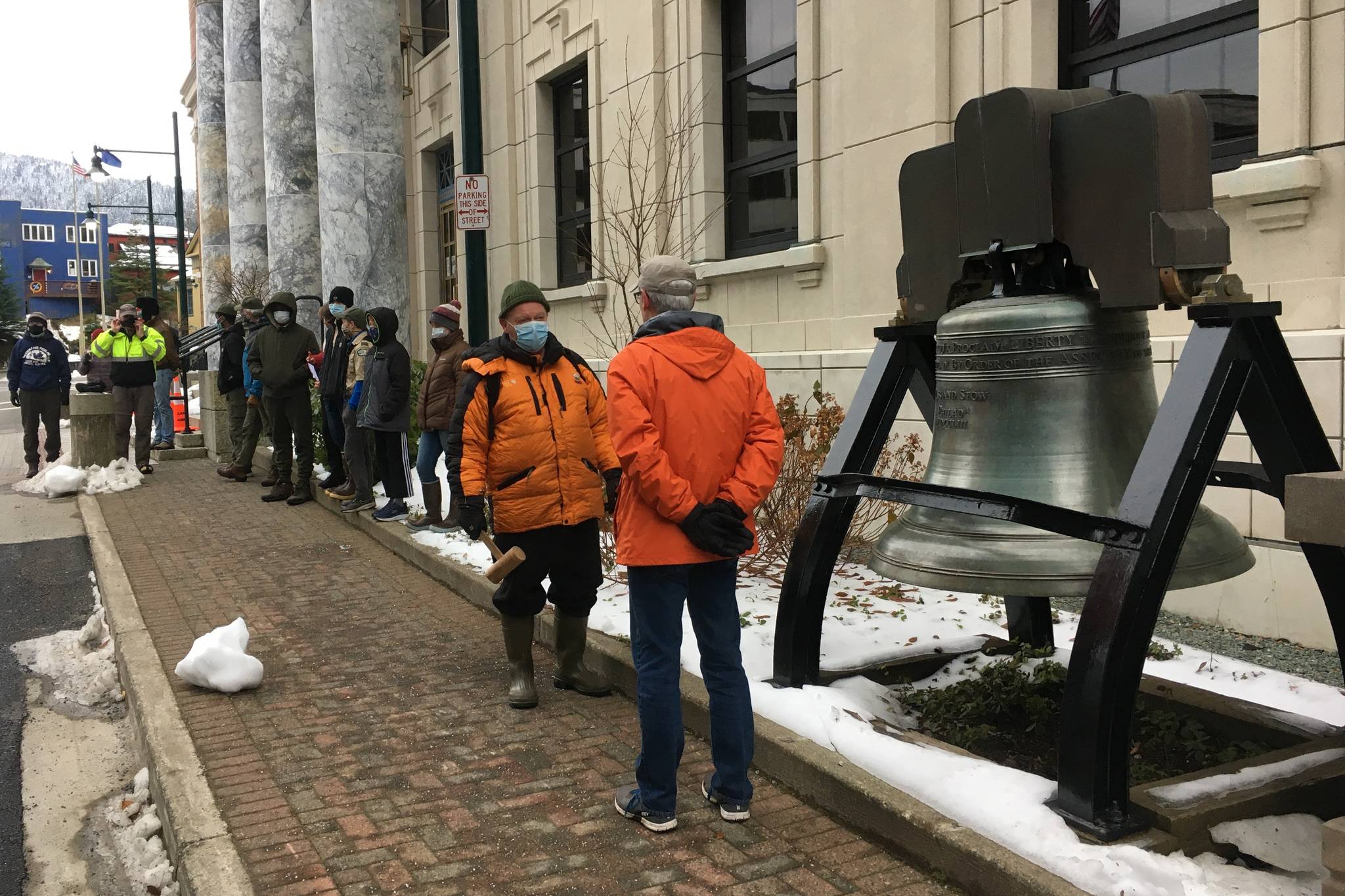 Craig Wilson, president of the Juneau chapter of Veterans for Peace, stands in front of the bell at the Alaska State Capitol as Juneau residents prepare to ring it in honor of Armistice Day, as Veterans Day was previously known on Nov. 11, 2020. (Michael S. Lockett / Juneau Empire)