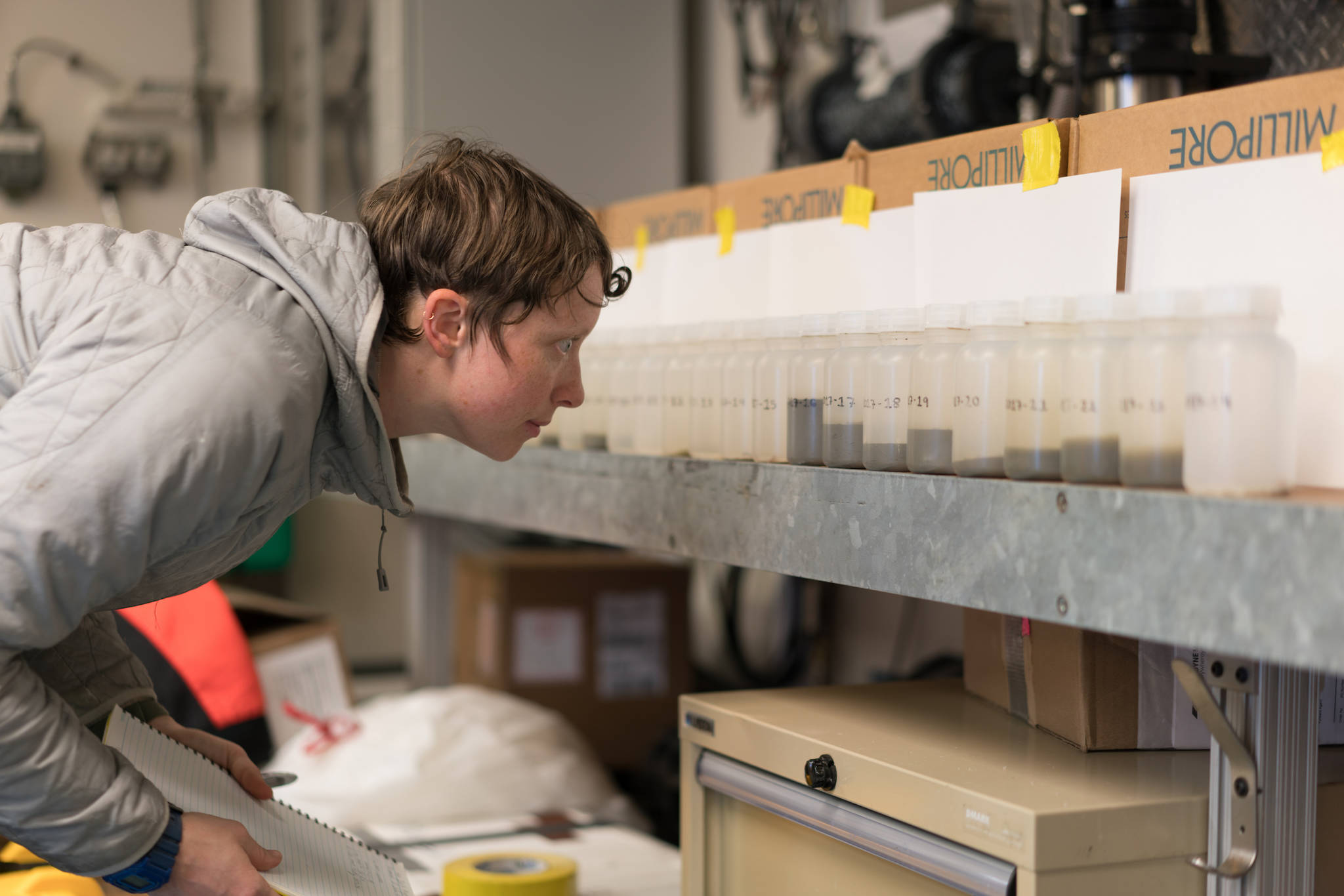 Steffi O’Daly looks at sea water samples from Bering Strait aboard the UAF research ship Sikuliaq. (Courtesy Photo / Andrew McDonnell)