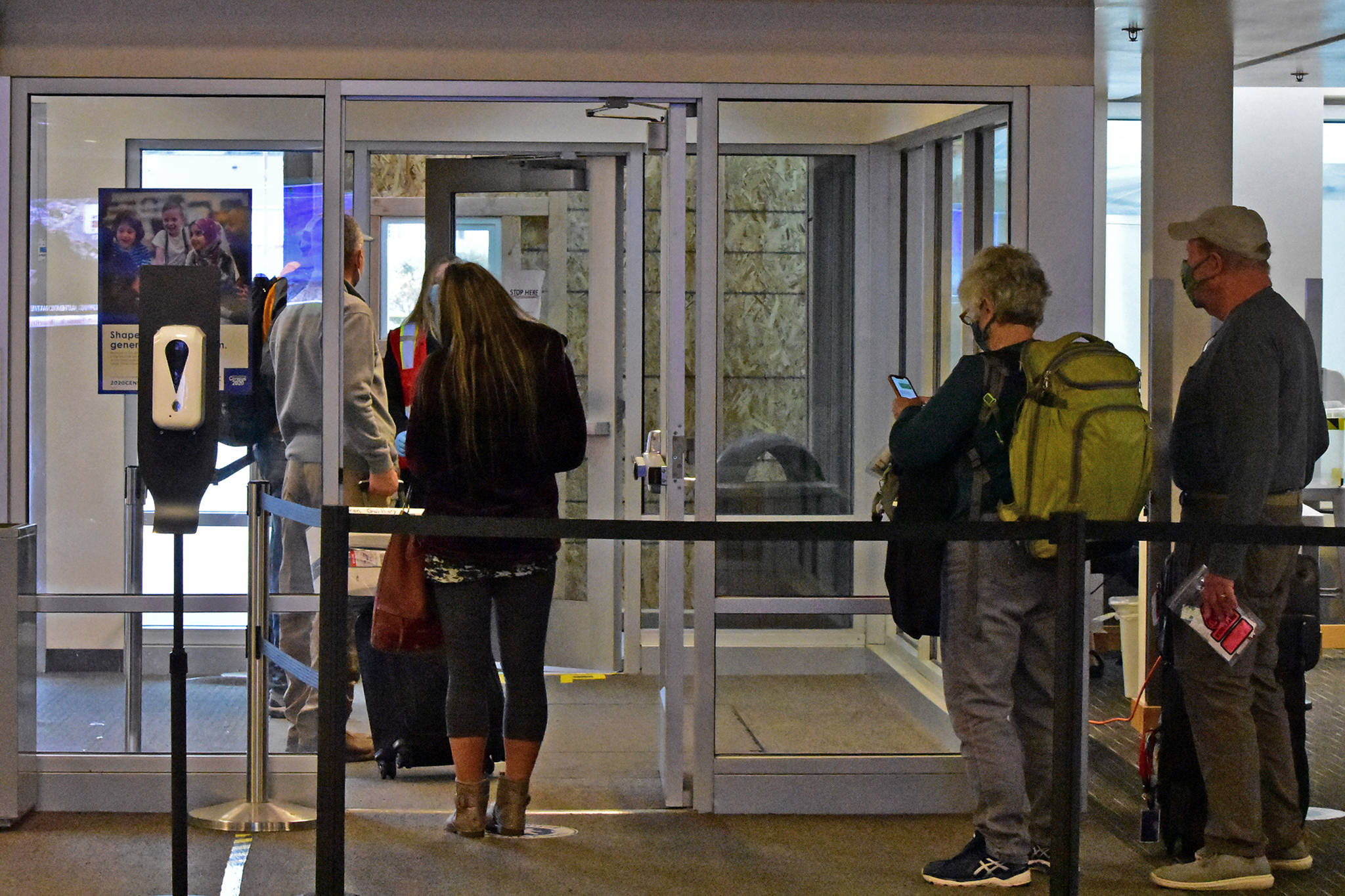 Travelers wait on Oct. 12 in Juneau International Airport to be tested for COVID-19. (Peter Segall / Juneau Empire File)