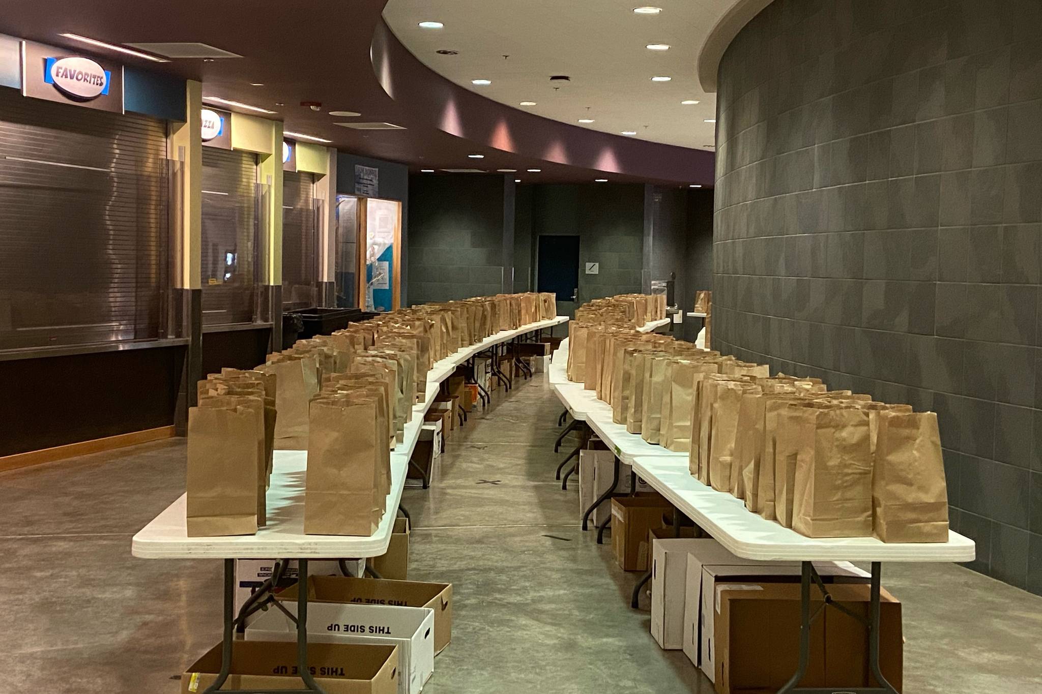 Meals slated for children in Juneau over Thanksgiving weekend are arrayed on tables at Thunder Mountain High School on Nov. 25, 2020. (Courtesy photo / Luke Adams)