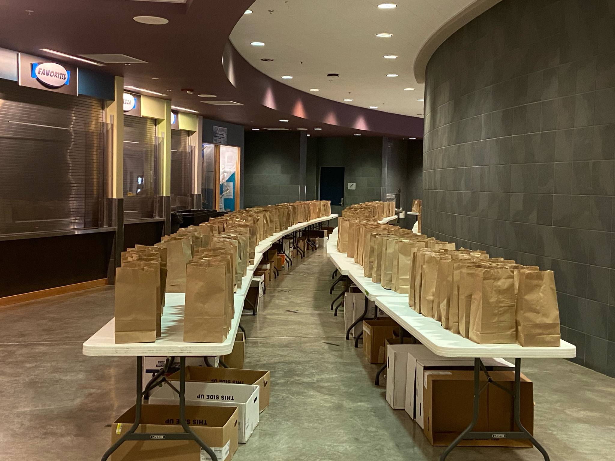 Meals slated for children in Juneau over Thanksgiving weekend are arrayed on tables at Thunder Mountain High School on Nov. 25, 2020. (Courtesy photo / Luke Adams)