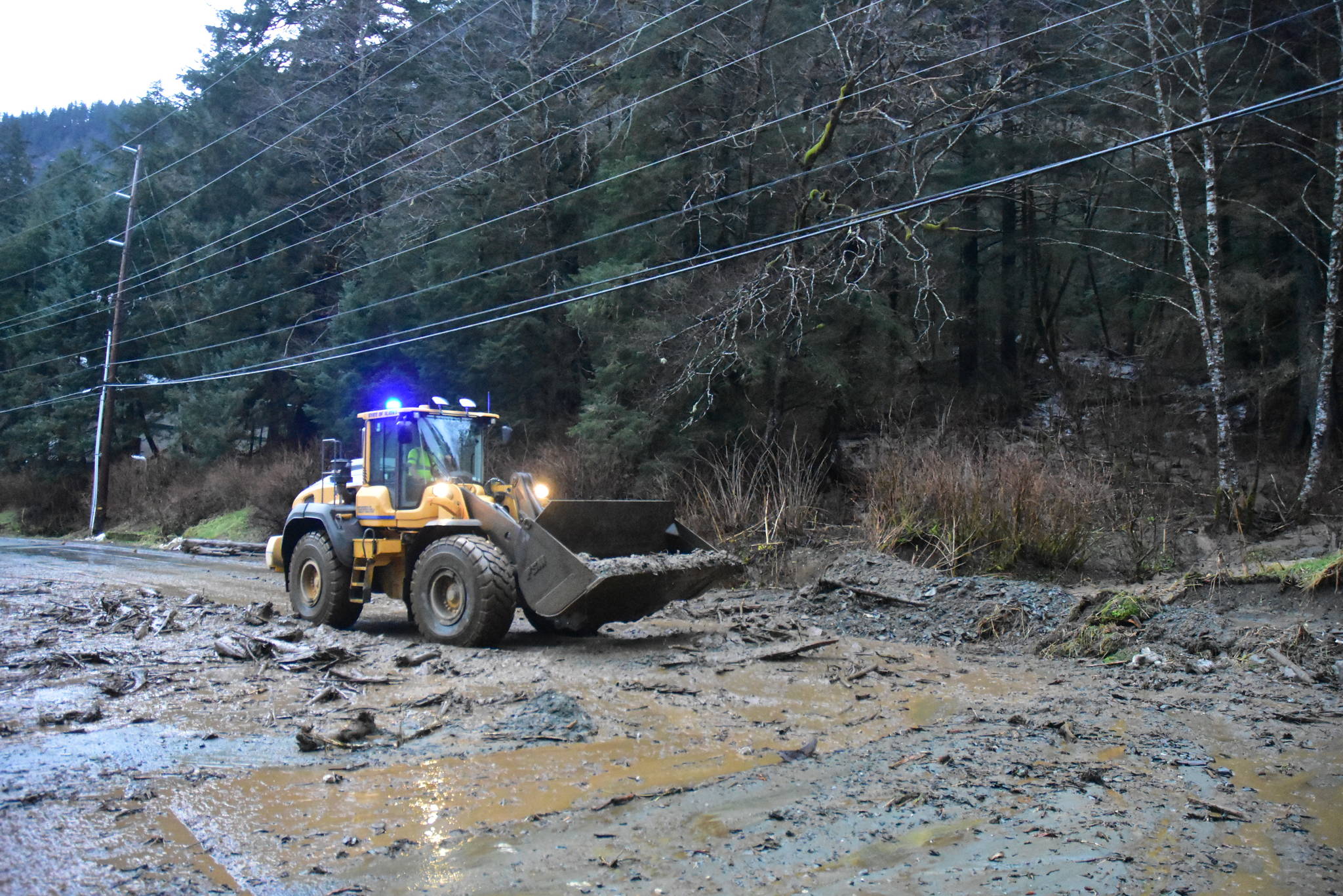 Heavy rains overnight caused a mudslide to wash across Glacier Highway just after 8 a.m. Wednesday, Dec. 2, 2020, partially flooding nearby buildings. (Peter Segall / Juneau Empire)