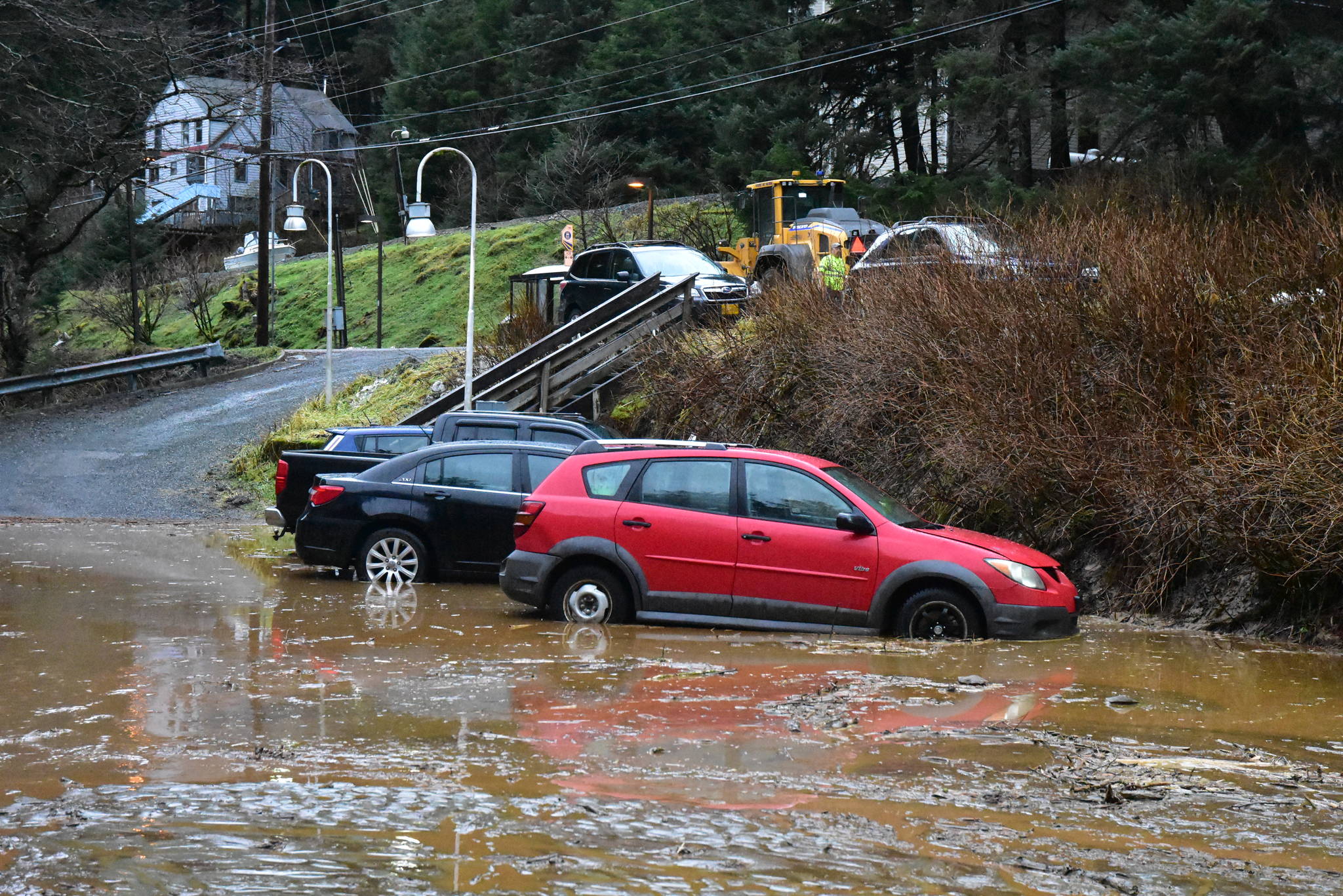 Muddy water and debris partially flooded a parking lot near Glacier Highway after heavy rains caused an early morning mudslide on Wednesday, Dec. 2, 2020. (Peter Segall / Juneau Empire)