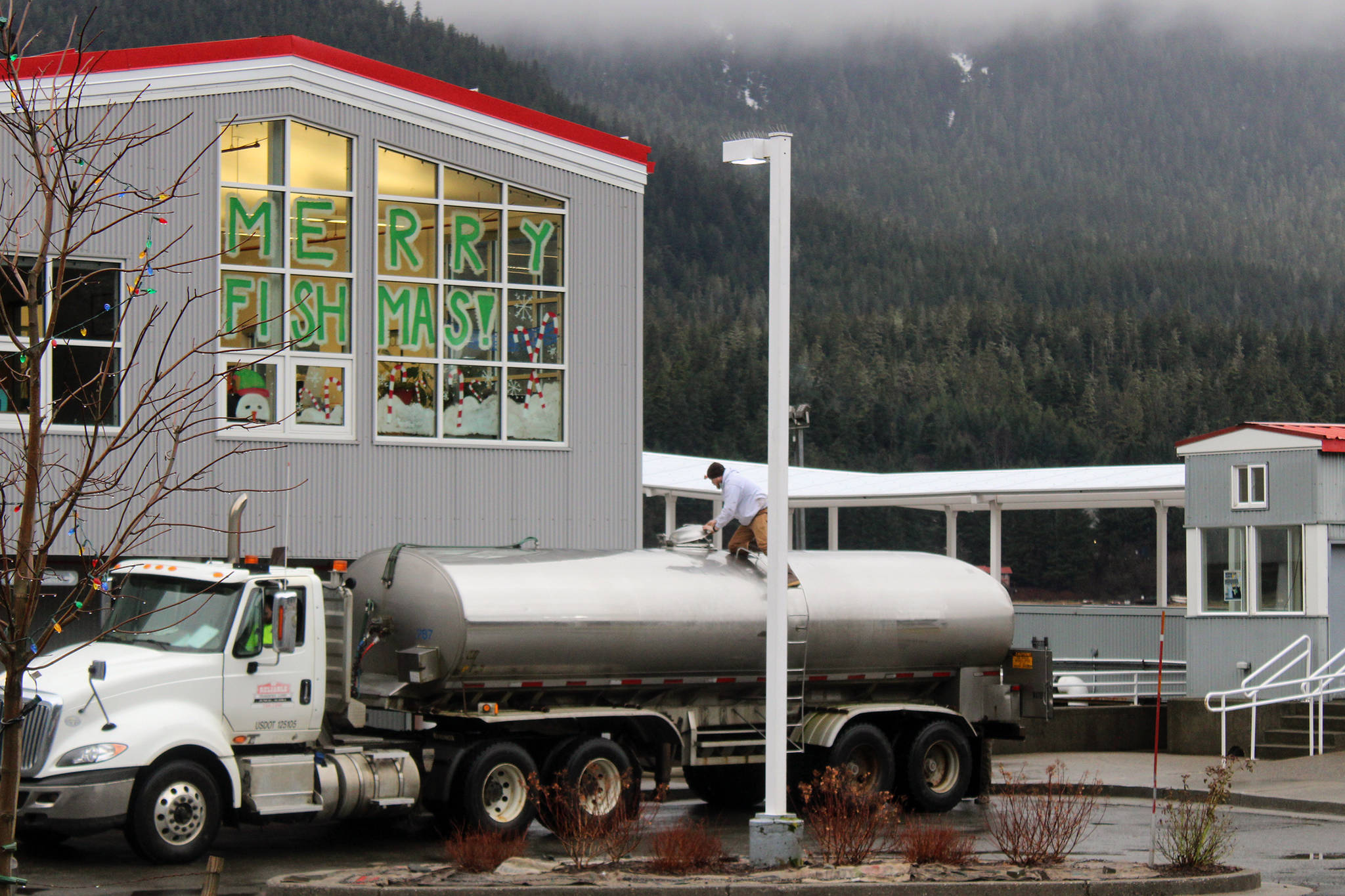 A truck stops outside Douglas Island Pink and Chum to pump in water on Thursday following damage to a pipeline caused by a landslide on Dec. 3, 2020. (Ben Hohenstatt / Juneau Empire)