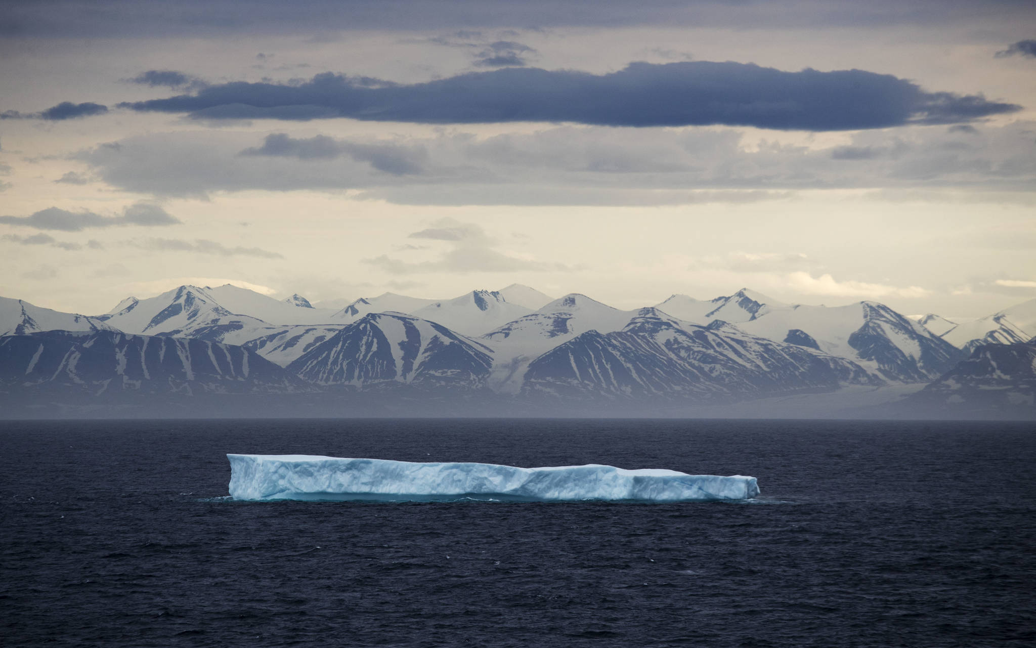 An iceberg floats past Bylot Island in the Canadian Arctic Archipelago. The National Oceanic and Atmospheric Administrations annual Arctic Report Card, released on Tuesday, Dec. 8, 2020, shows how warming temperatures in the Arctic are transforming the regions geography and ecosystems. (AP Photo/David Goldman, File)