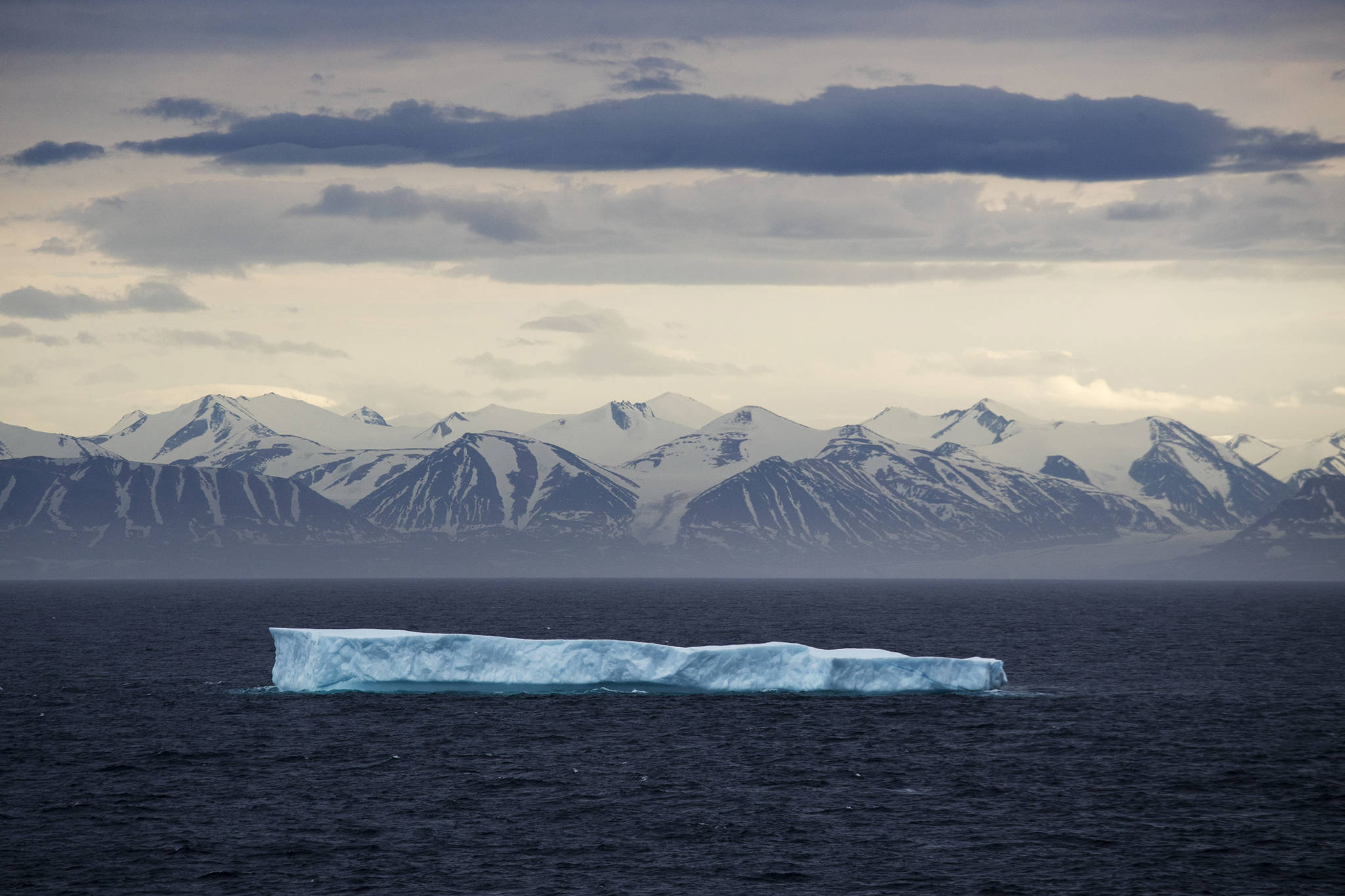 An iceberg floats past Bylot Island in the Canadian Arctic Archipelago. The National Oceanic and Atmospheric Administration’s annual Arctic Report Card, released on Tuesday, Dec. 8, 2020, shows how warming temperatures in the Arctic are transforming the region’s geography and ecosystems. (AP Photo/David Goldman, File)