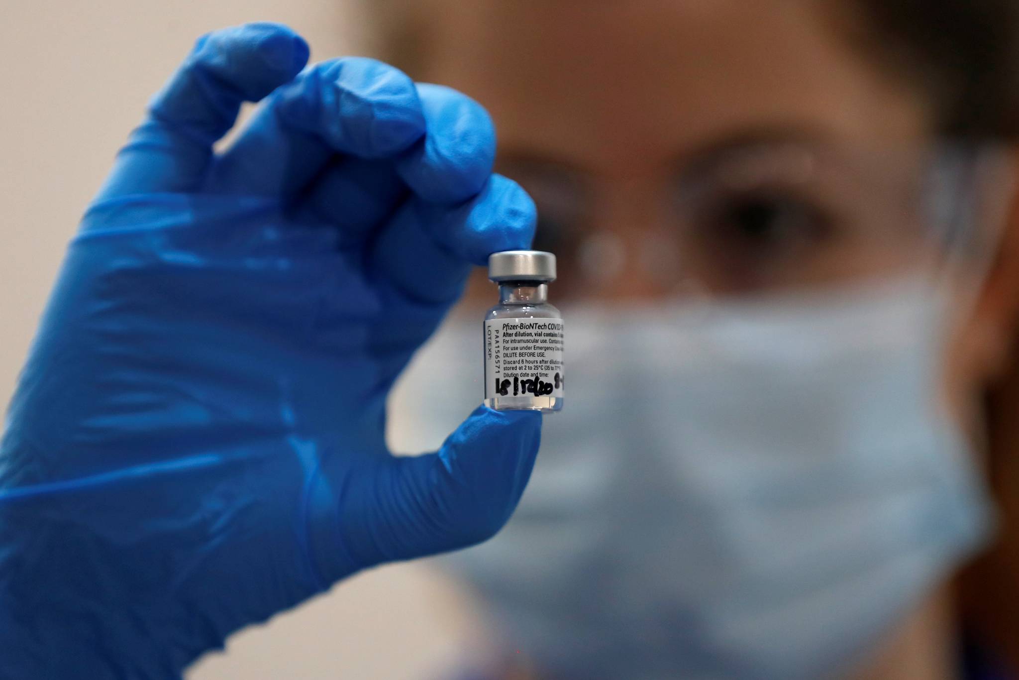A nurse holds a phial of the Pfizer-BioNTech COVID-19 vaccine at Guy’s Hospital in London, Tuesday, Dec. 8, 2020, as the U.K. health authorities rolled out a national mass vaccination program. U.K. regulators said Wednesday Dec. 9, 2020, that people who have a “significant history’’ of allergic reactions shouldn’t receive the new Pfizer/BioNTech vaccine while they investigate two adverse reactions that occurred on the first day of the country’s mass vaccination program. (AP Photo/Frank Augstein, Pool)