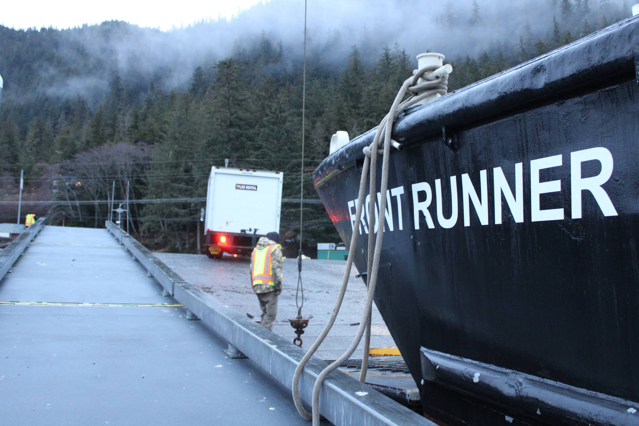 A truck backs up onto a Haines-bound boat on Dec. 3, 2020, as part of an effort to send supplies and people to the landslide-afflicted community. (Ben Hohenstatt / Juneau Empire)