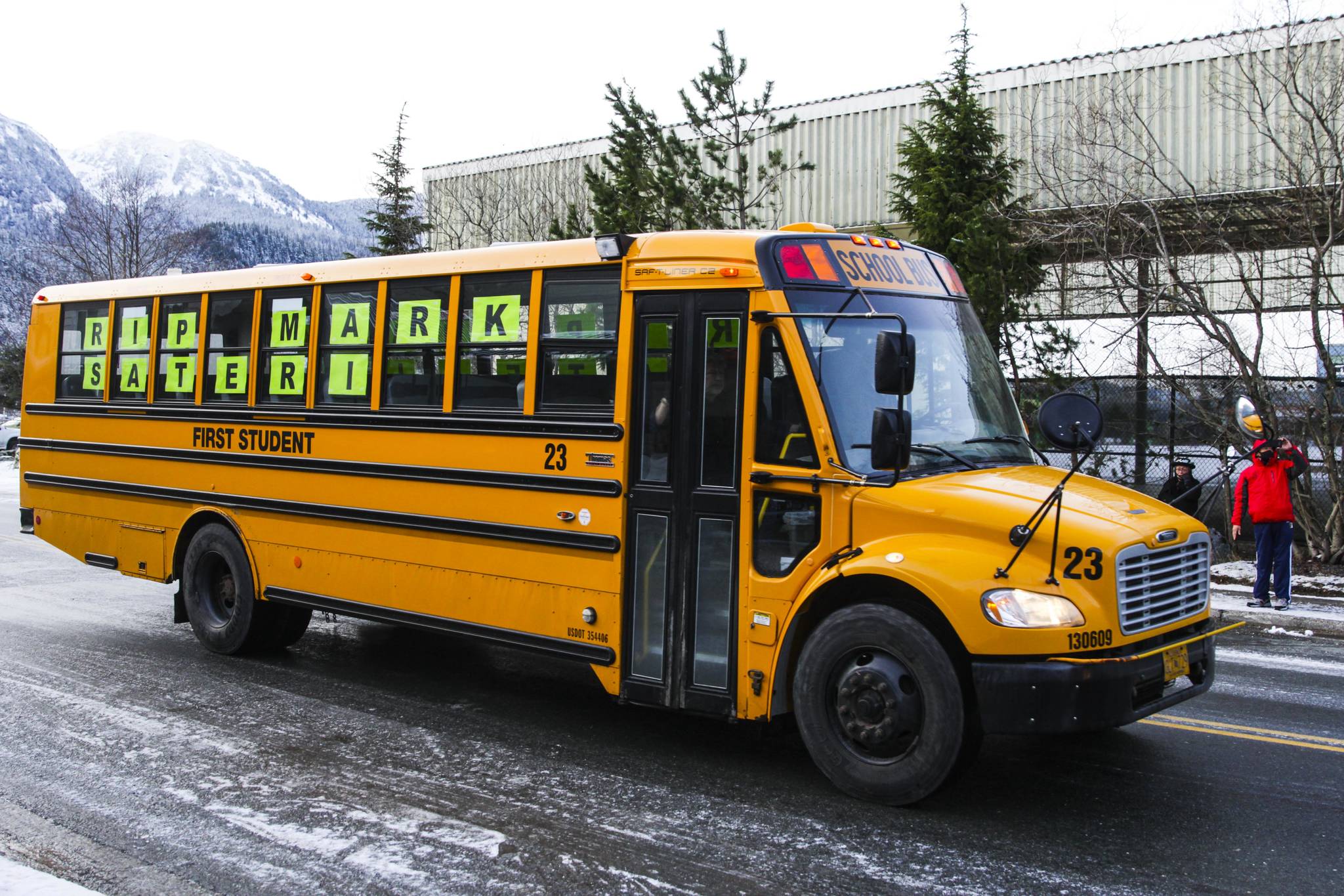 First Student Inc. held a bus parade Saturday to remember recently killed employee Mark Sateri, driving by the Mountain View Apartments where Sateri lived and died as residents came out to remember him, Dec. 12, 2020. (Michael S. Lockett / Juneau Empire)